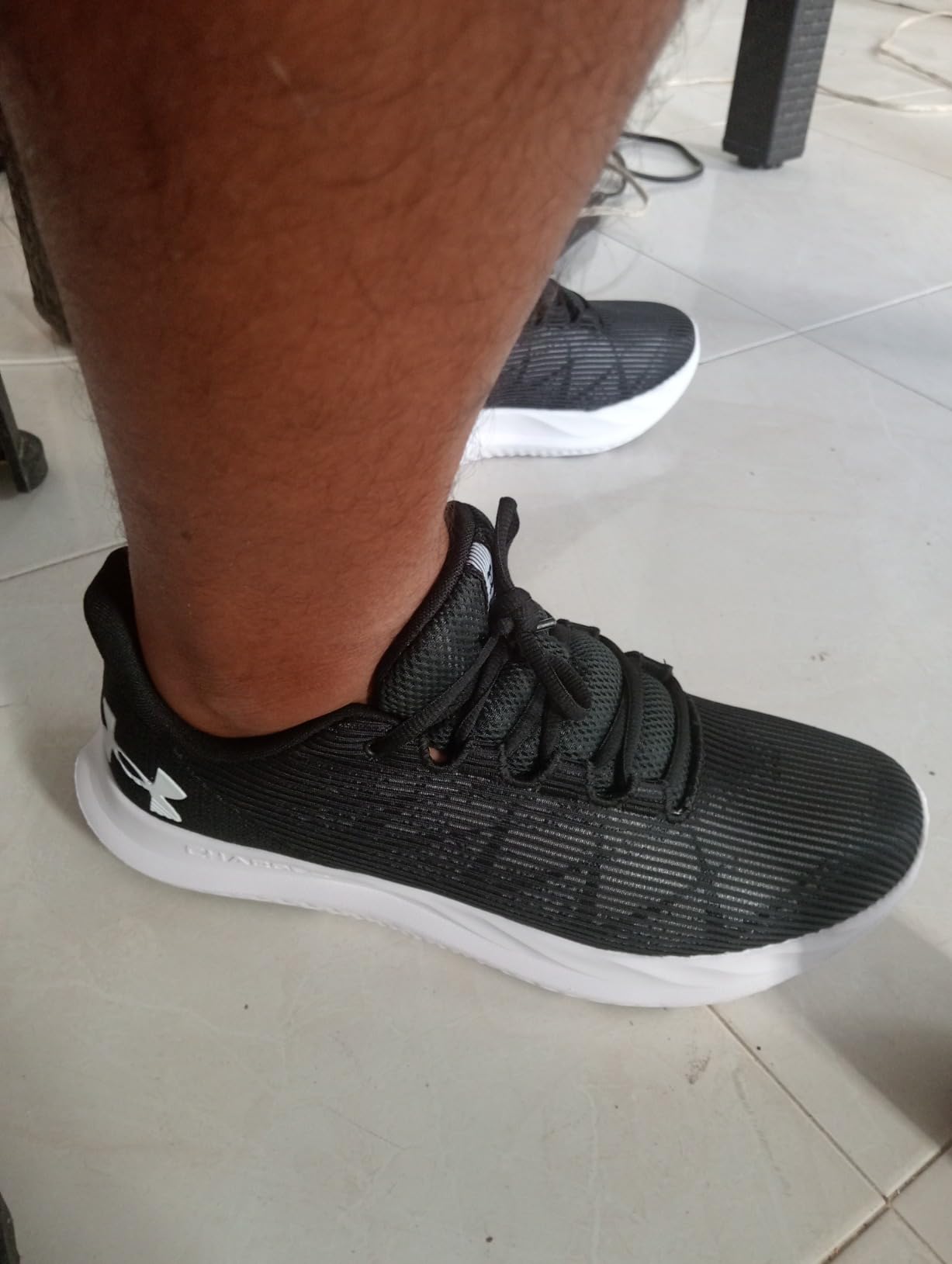 Under Armour Charged Speed Swift side profile showing mesh upper construction and rubber outsole design