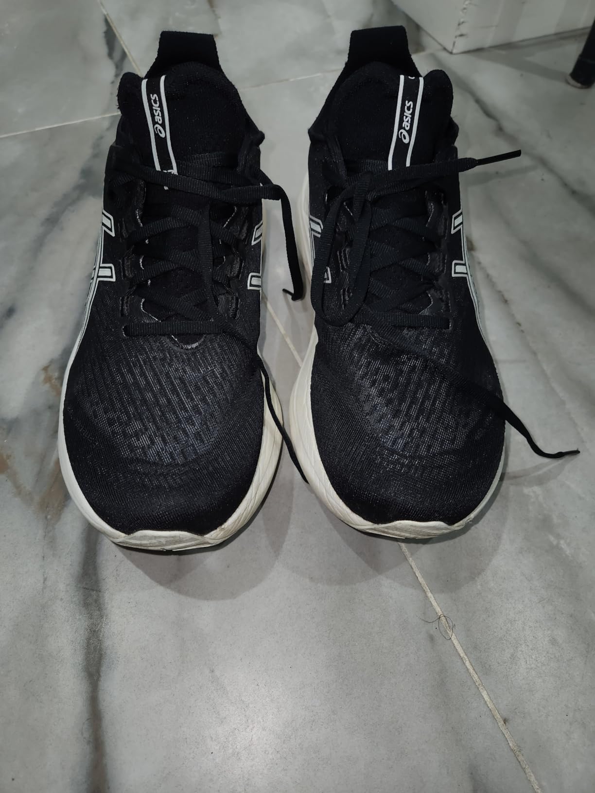 Asics Men's Gel-Nimbus 27 running shoe showing engineered knit upper and maximum cushioning design