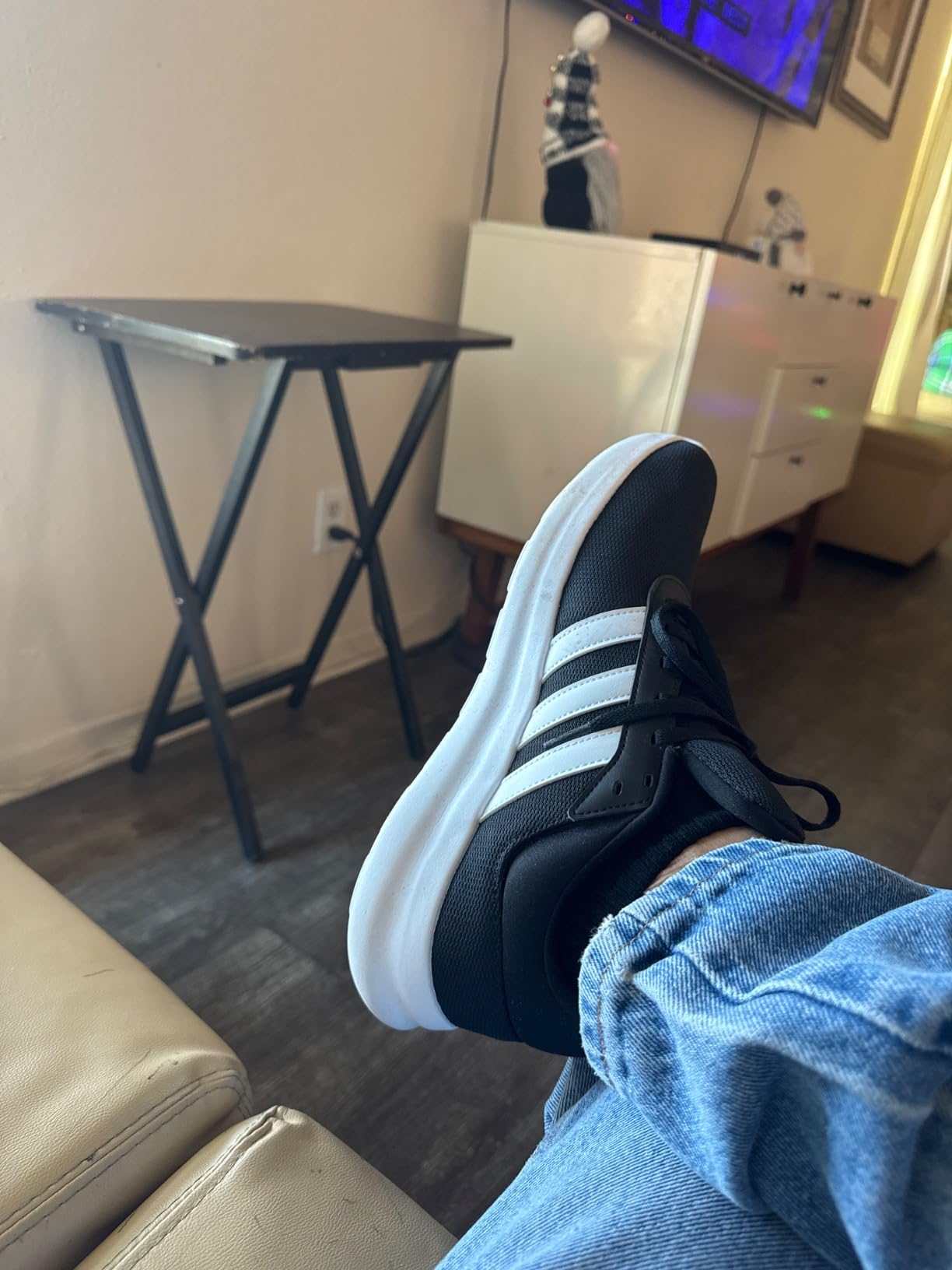 Close-up detail shot of Adidas Lite Racer 4.0 showing mesh upper construction and classic three stripes design