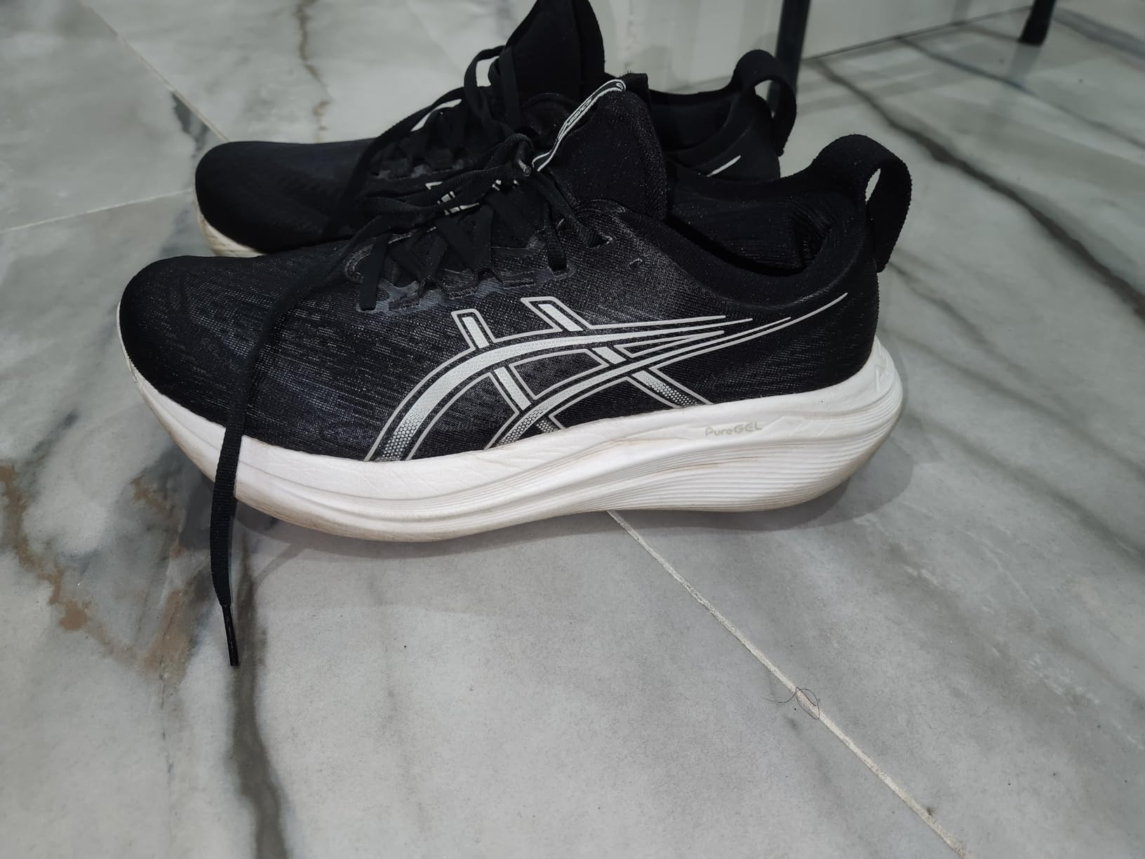 Close-up detail of Asics Gel-Nimbus 27 engineered knit upper and comfort features