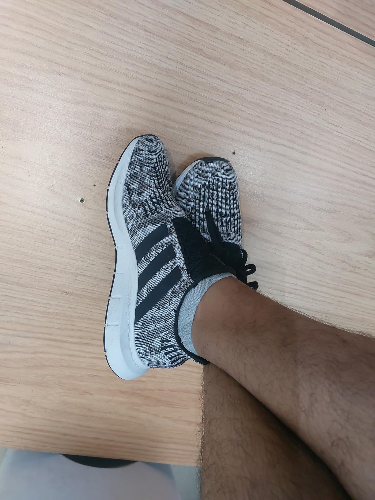 Adidas Men's Swift Run black colorway showing sleek lifestyle sneaker design