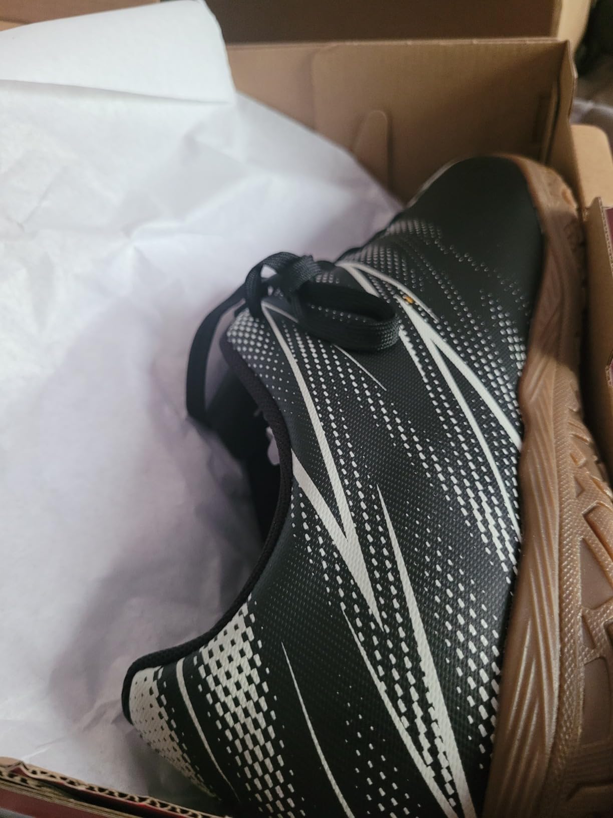 PUMA Attacanto indoor soccer shoe detail shot showing synthetic upper construction and lacing system