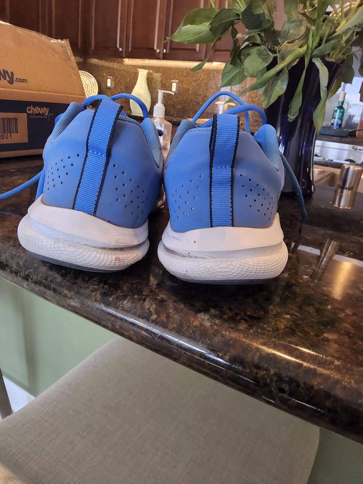 Under Armour Assert 9 side view showing mesh upper construction and leather overlays