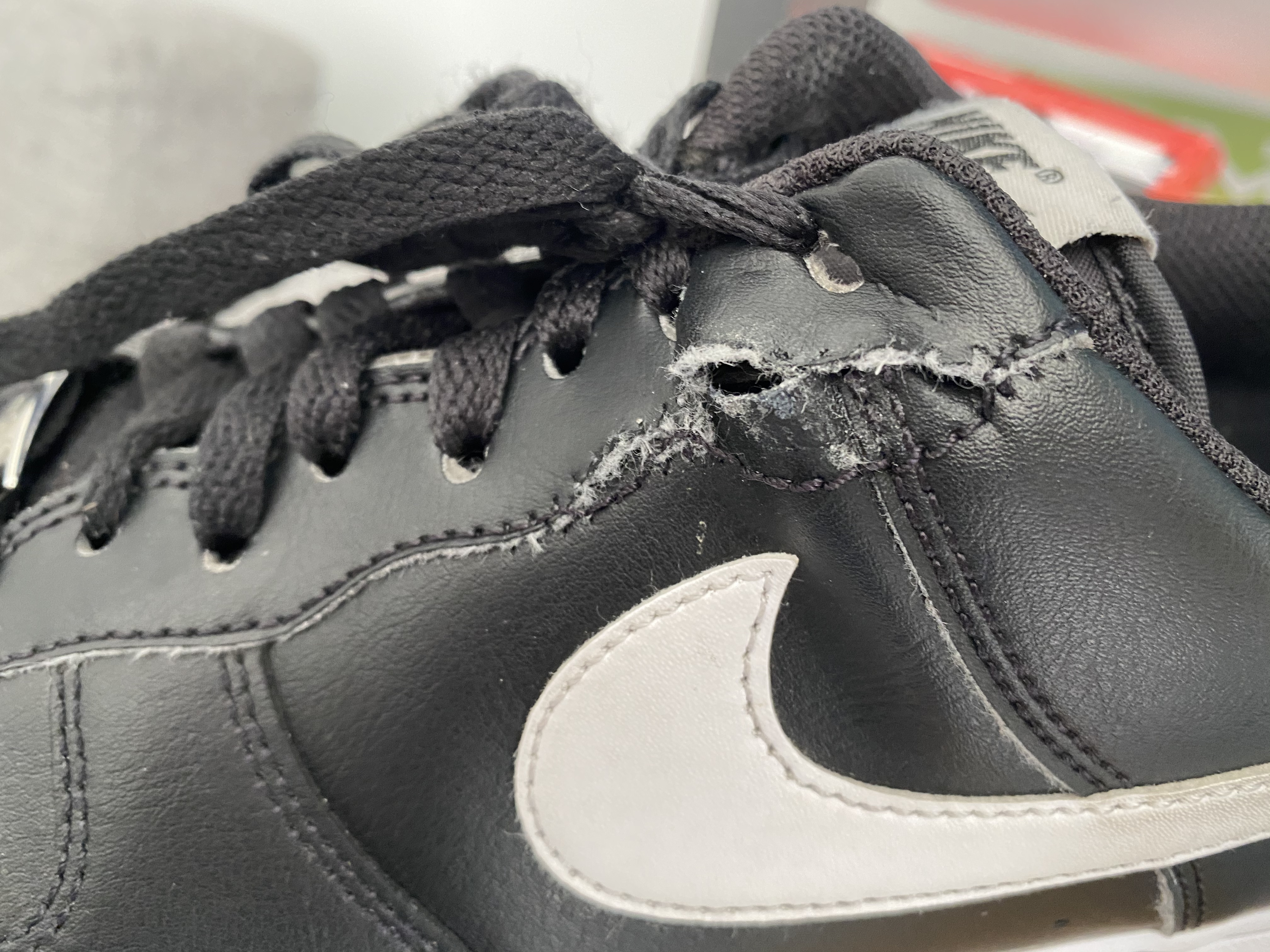 Nike Air Force 1 showing wear pattern after extended use with visible creasing on leather upper