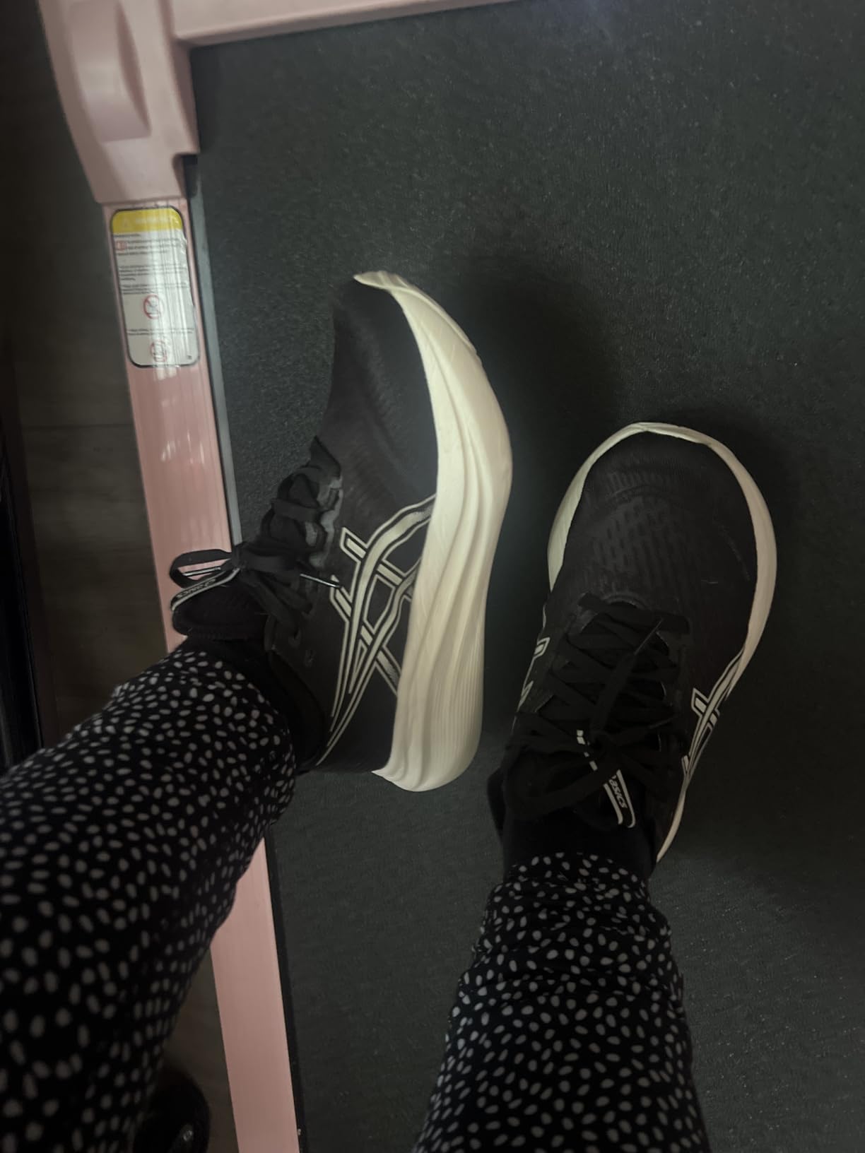 ASICS Women's Gel-Nimbus 27 running shoes showing navy and coral colorway with maximum cushioning design