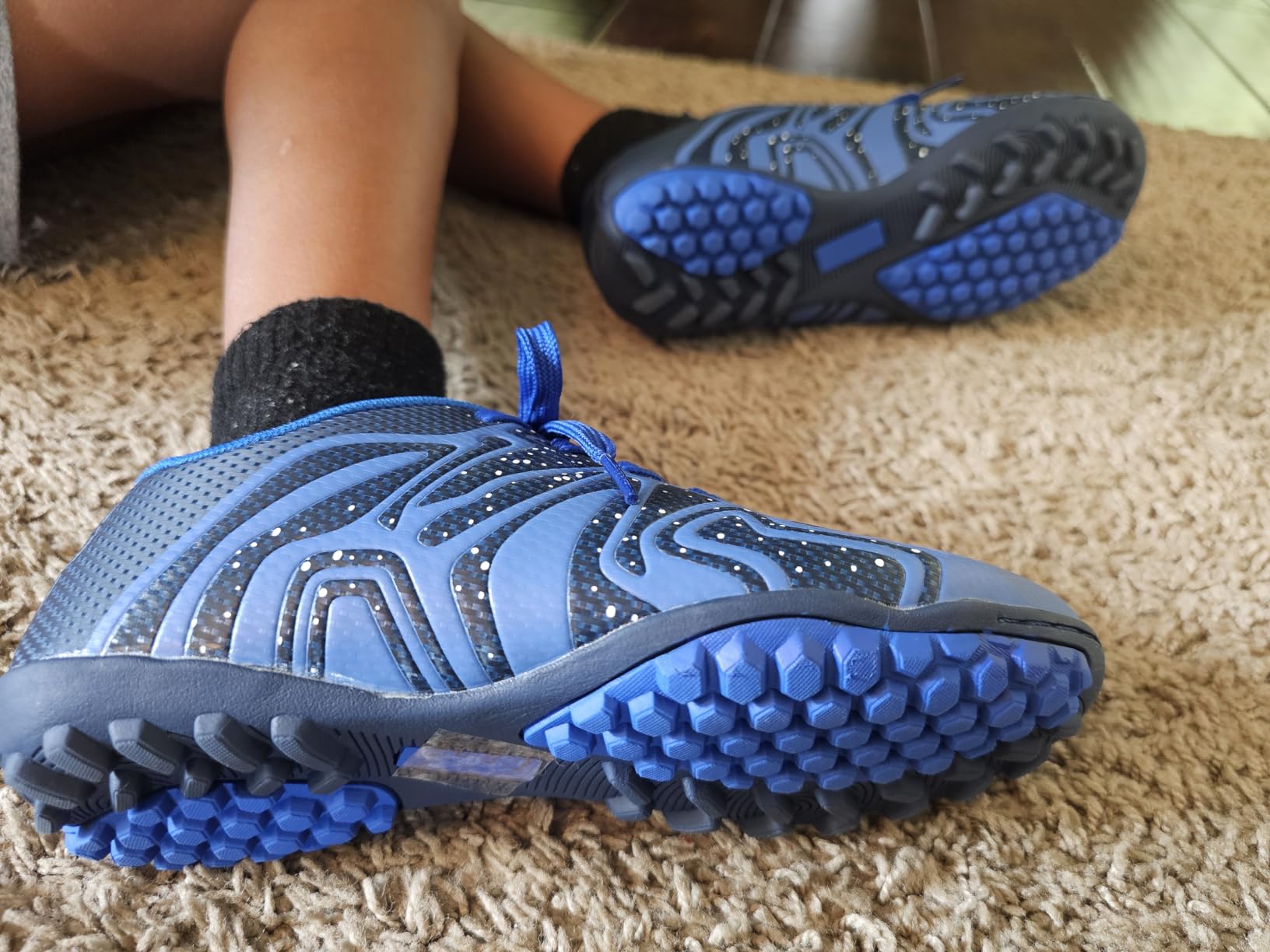 DREAM PAIRS soccer cleats showing grip pattern and sole design for indoor performance