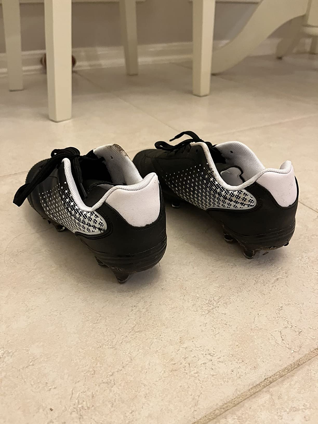 LIZRHA kids soccer cleats photographed on artificial turf field showing side profile and cleat pattern in action