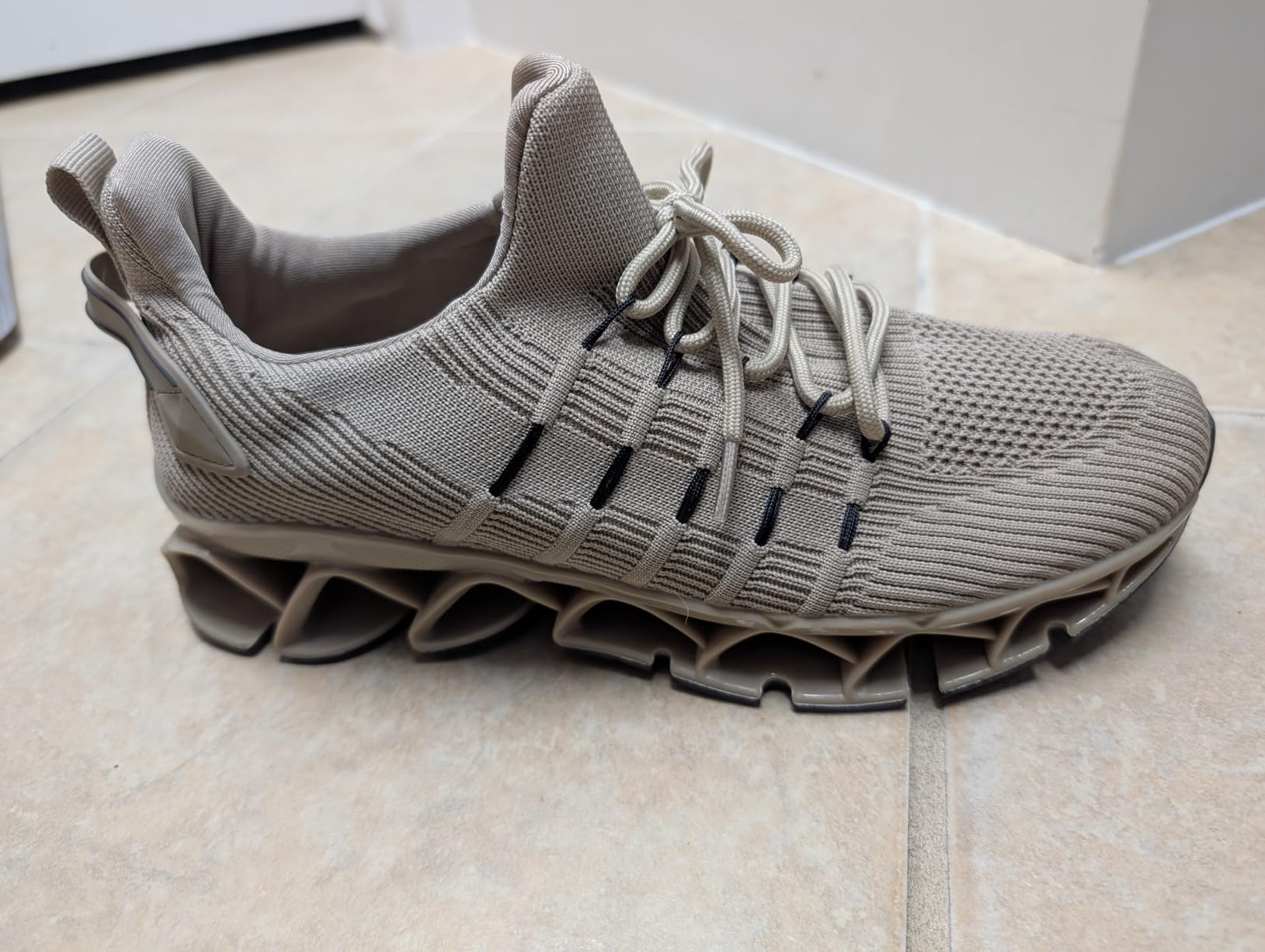 Close-up detail of mesh upper and blade sole pattern showing construction quality