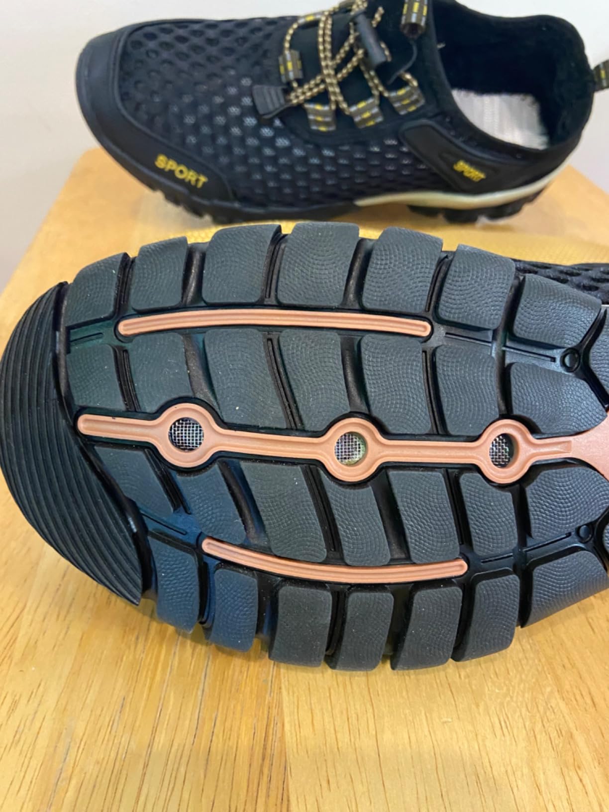 Close-up view of TrailBlitz water shoe drainage system and mesh construction details