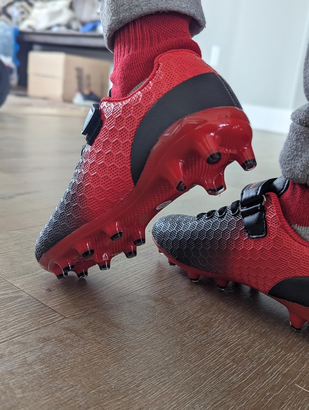 Close-up of BomKinta soccer cleats showing synthetic upper material and TPU sole construction