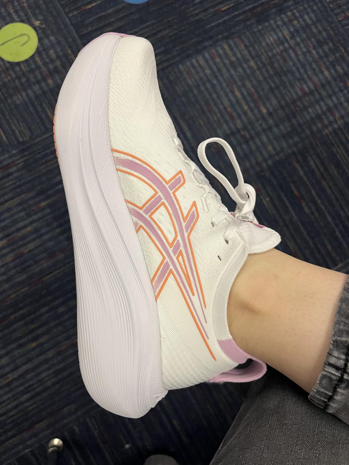 ASICS Gel-Nimbus 27 showing ube tangerine colorway perfect for energetic workouts and daily activities