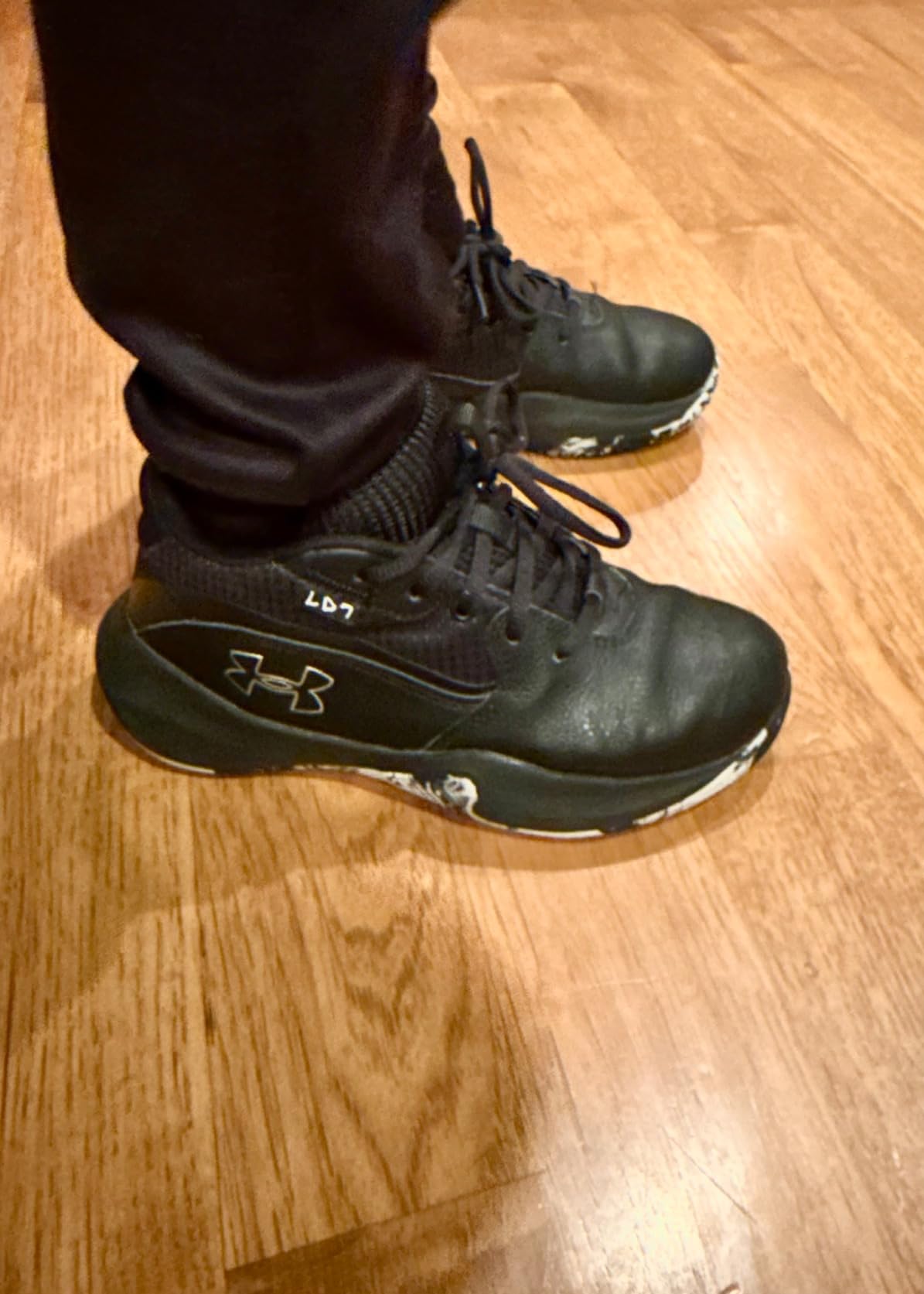 Under Armour Lockdown 7 kids basketball shoes in black and metallic silver colorway