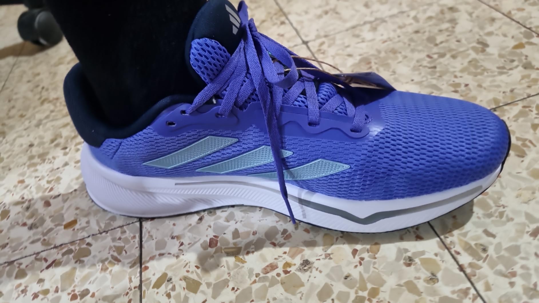 Adidas Response running shoe detail shot showing OrthoLite sockliner and mesh breathability