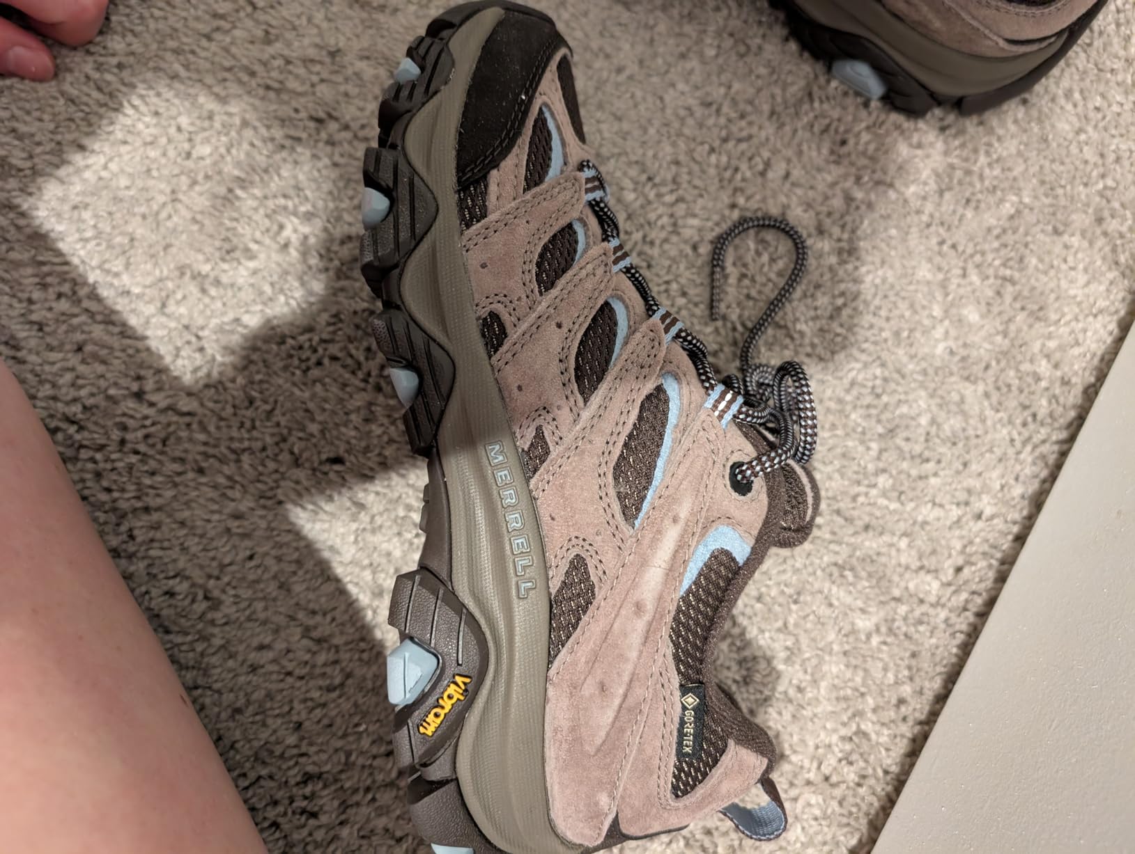 Merrell Moab 3 low-cut profile showing ankle height, lacing system, and suede leather panels