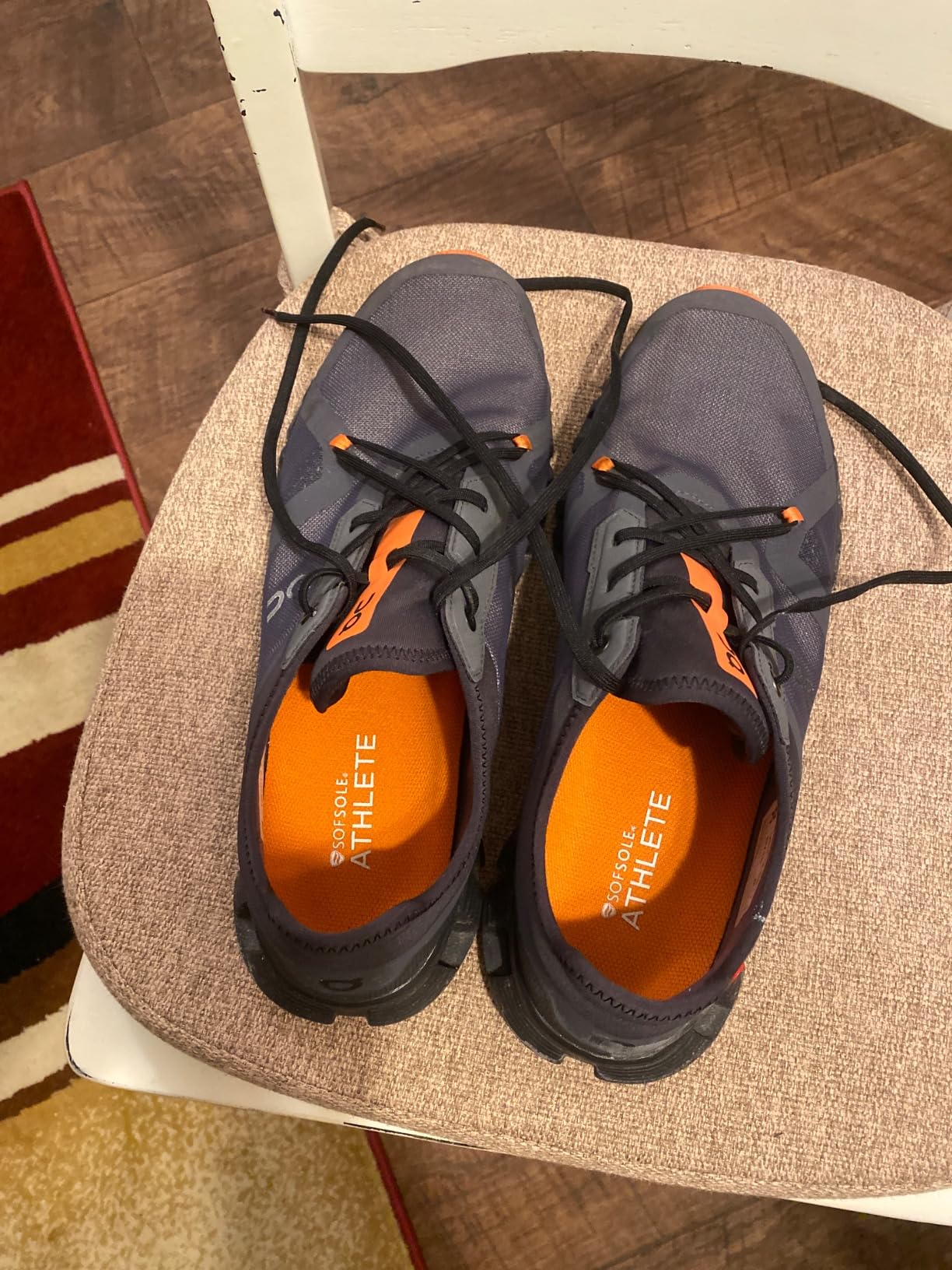 Close-up of Sof Sole Athlete insole showing gel pads and ventilation holes in orange and black design