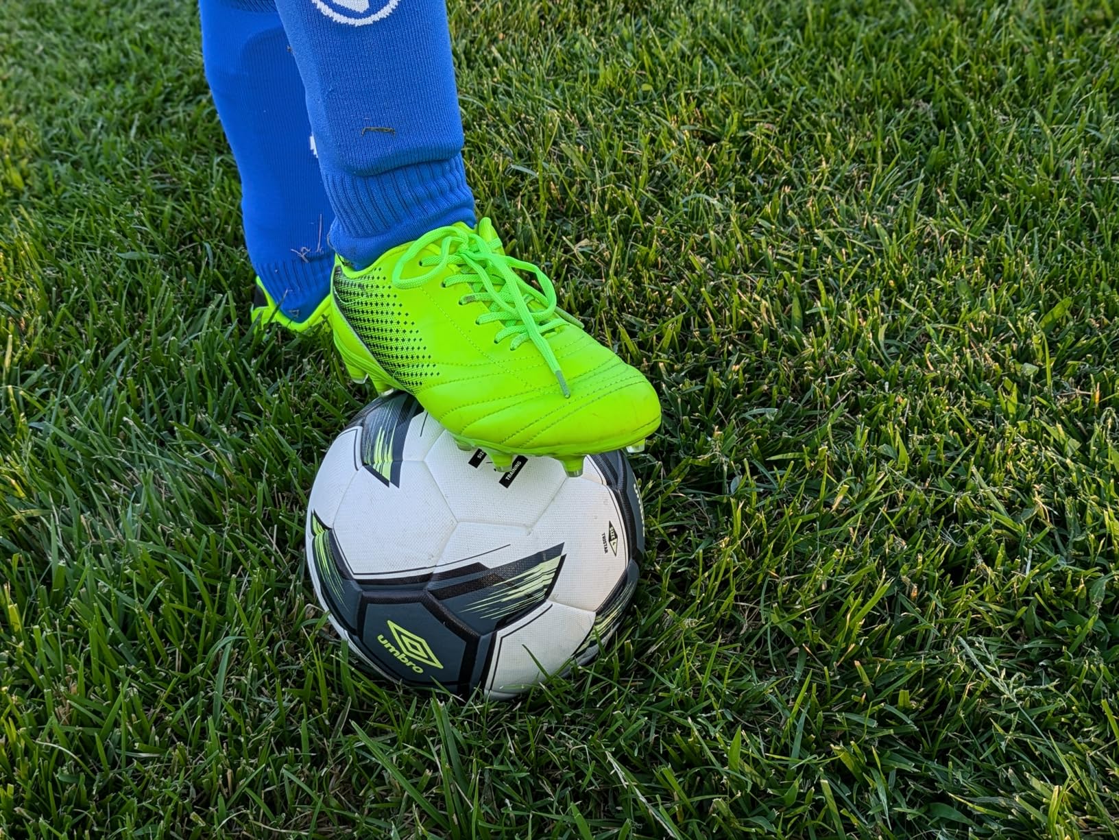 Close-up detail shot of LIZRHA soccer cleats showing synthetic upper construction, lace system, and padded tongue design