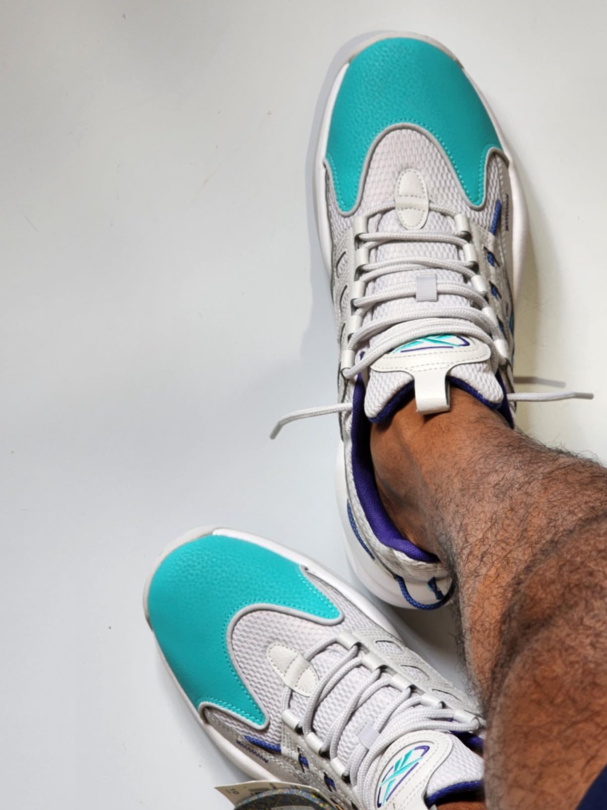 Reebok Solution Mid Basketball Shoe black and white colorway showing mid-top design and classic silhouette