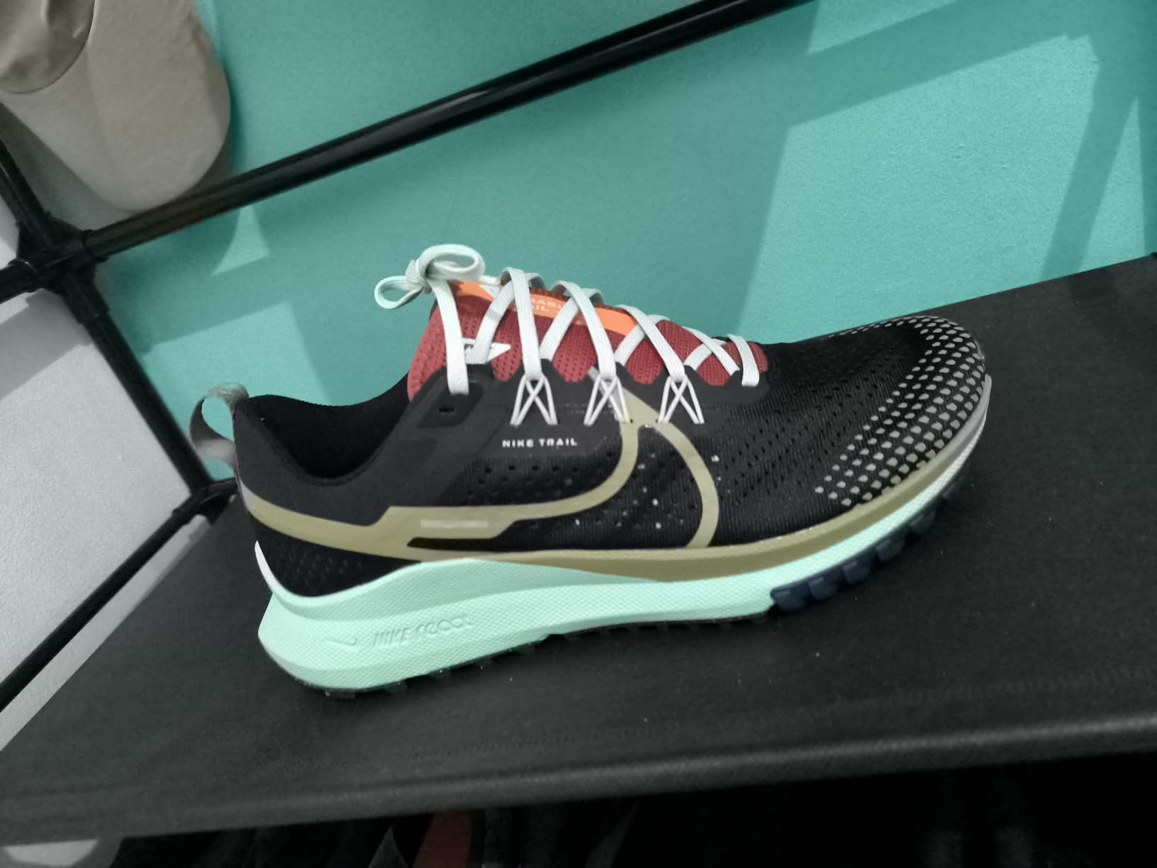 Nike trail running shoe in action on rugged trail terrain