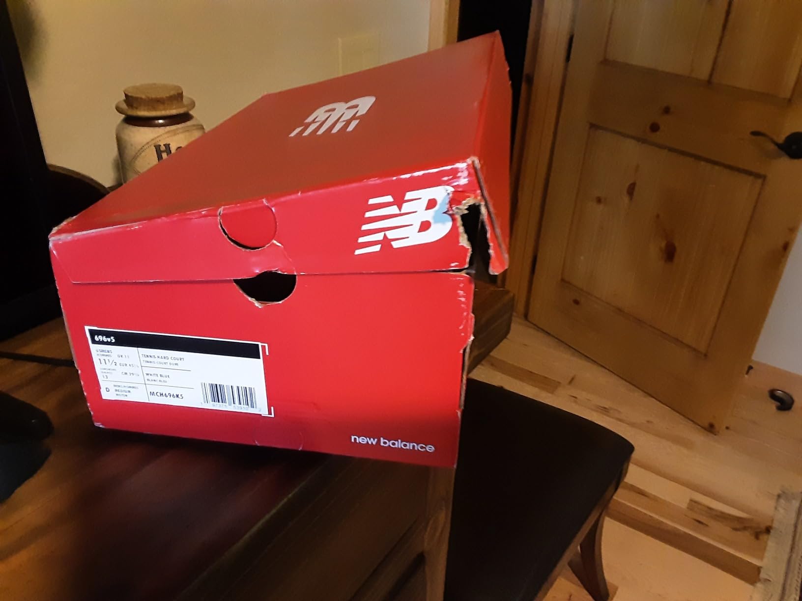 New Balance Men's 696 V5 side view showing mesh ventilation panels and support structure balancing breathability with durability