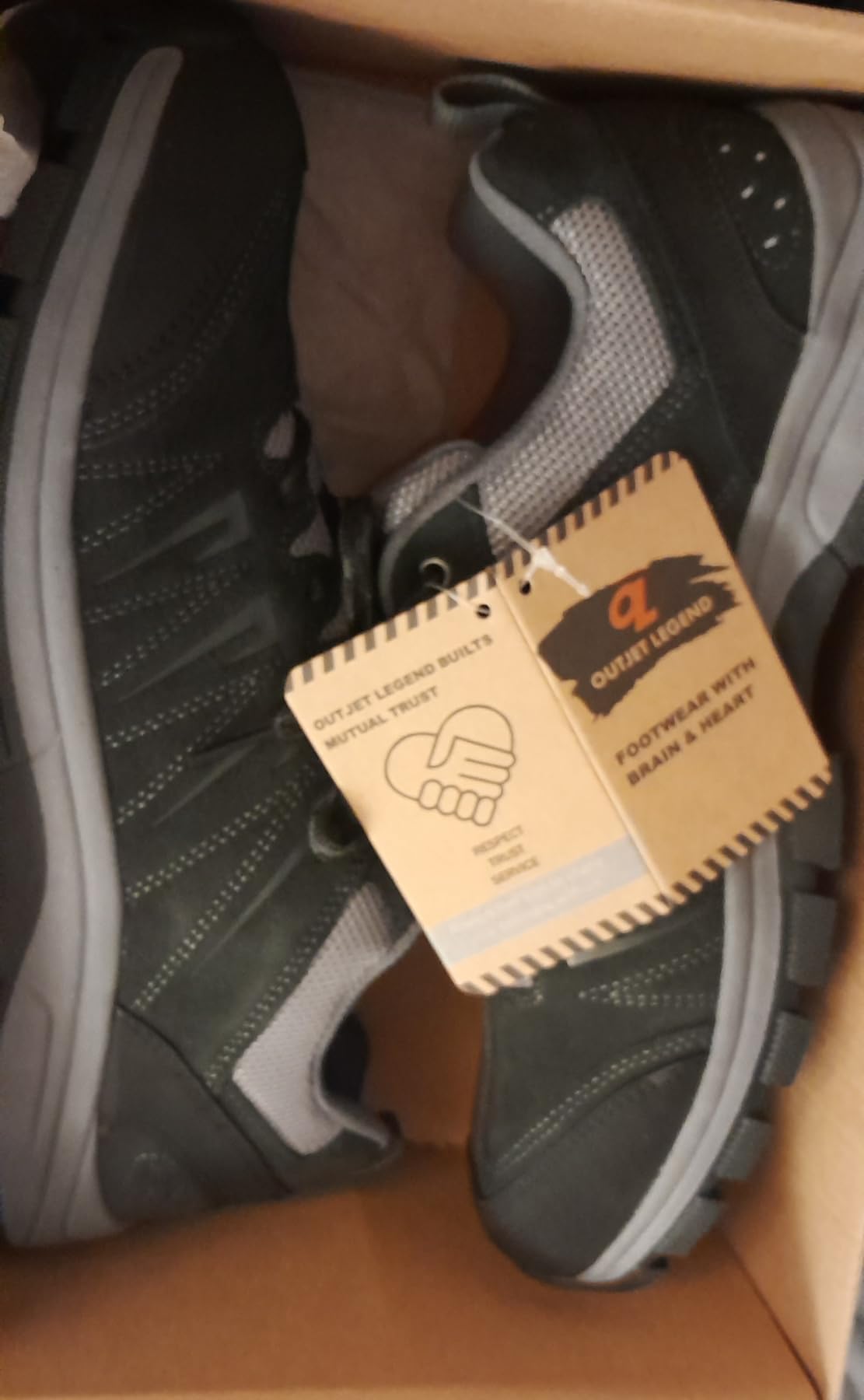 OL OUTJET LEGEND outsole showing deep multi-directional rubber tread lugs designed for grip on wet rocks, mud, and loose terrain