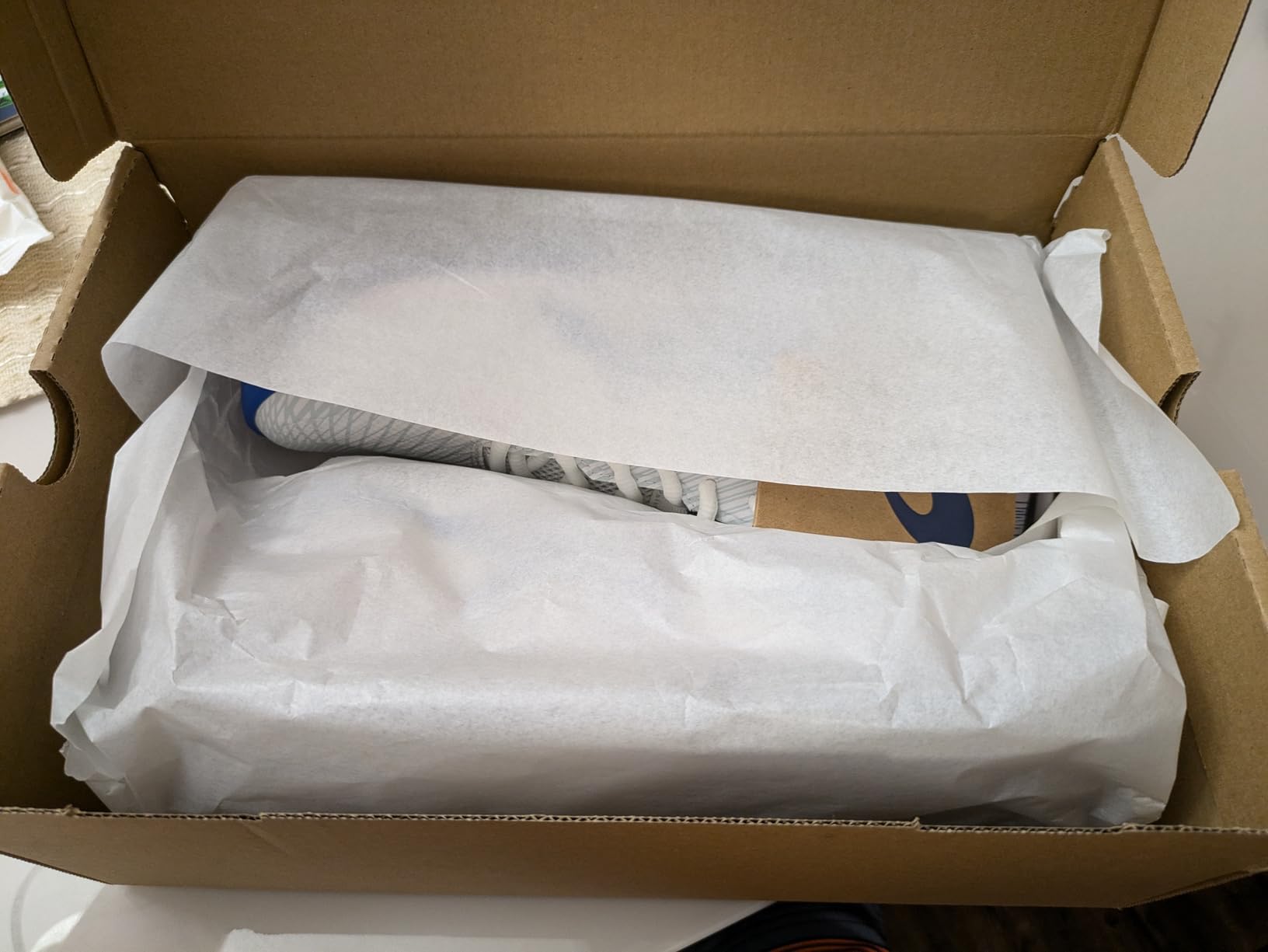 Side profile of ASICS Solution Swift FlyteFoam 2 showing split outsole design and TRUSSTIC technology visible through midsole