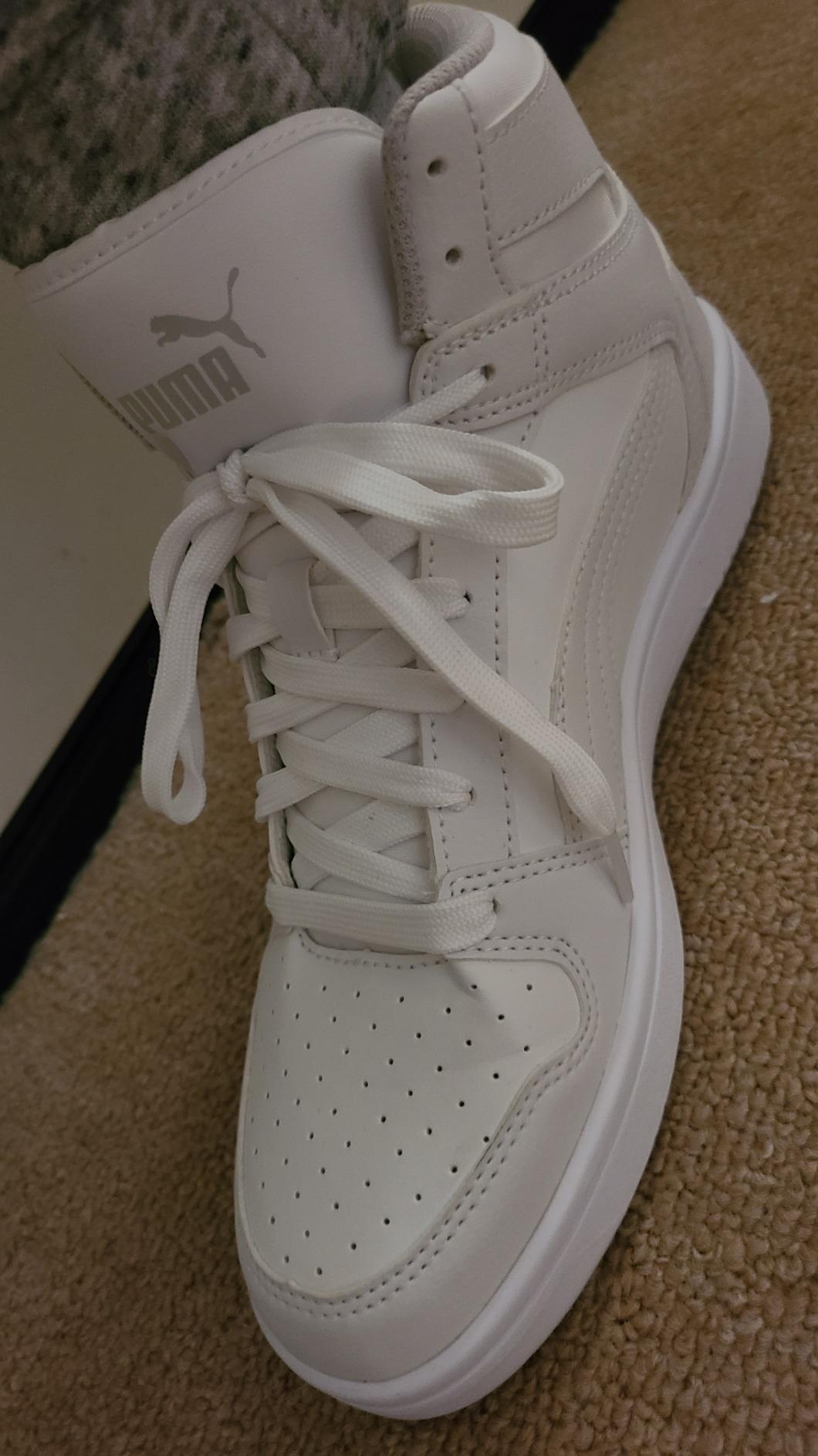 PUMA Rebound Layup Mid kids basketball shoes being worn outdoors showing versatility for various environments