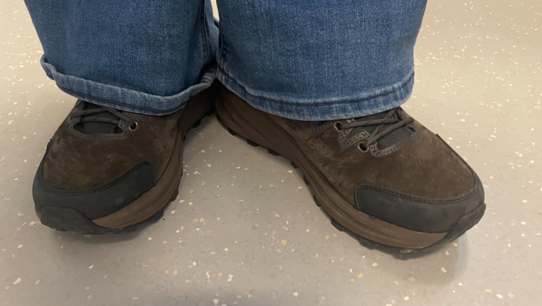 Close-up of NORTIV 8 showing pigskin leather texture, mesh breathing panels, rubber toe cap protection