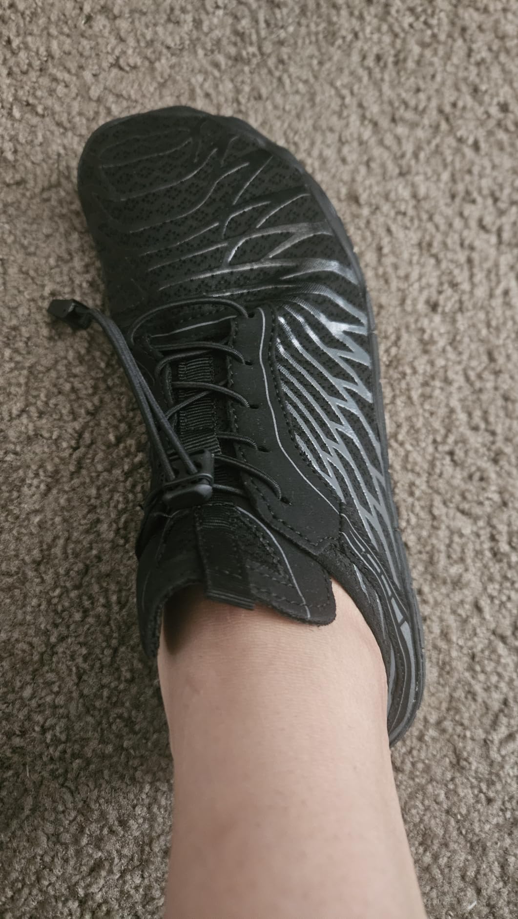 Titype barefoot shoe outsole showing drainage holes and flexible tread pattern