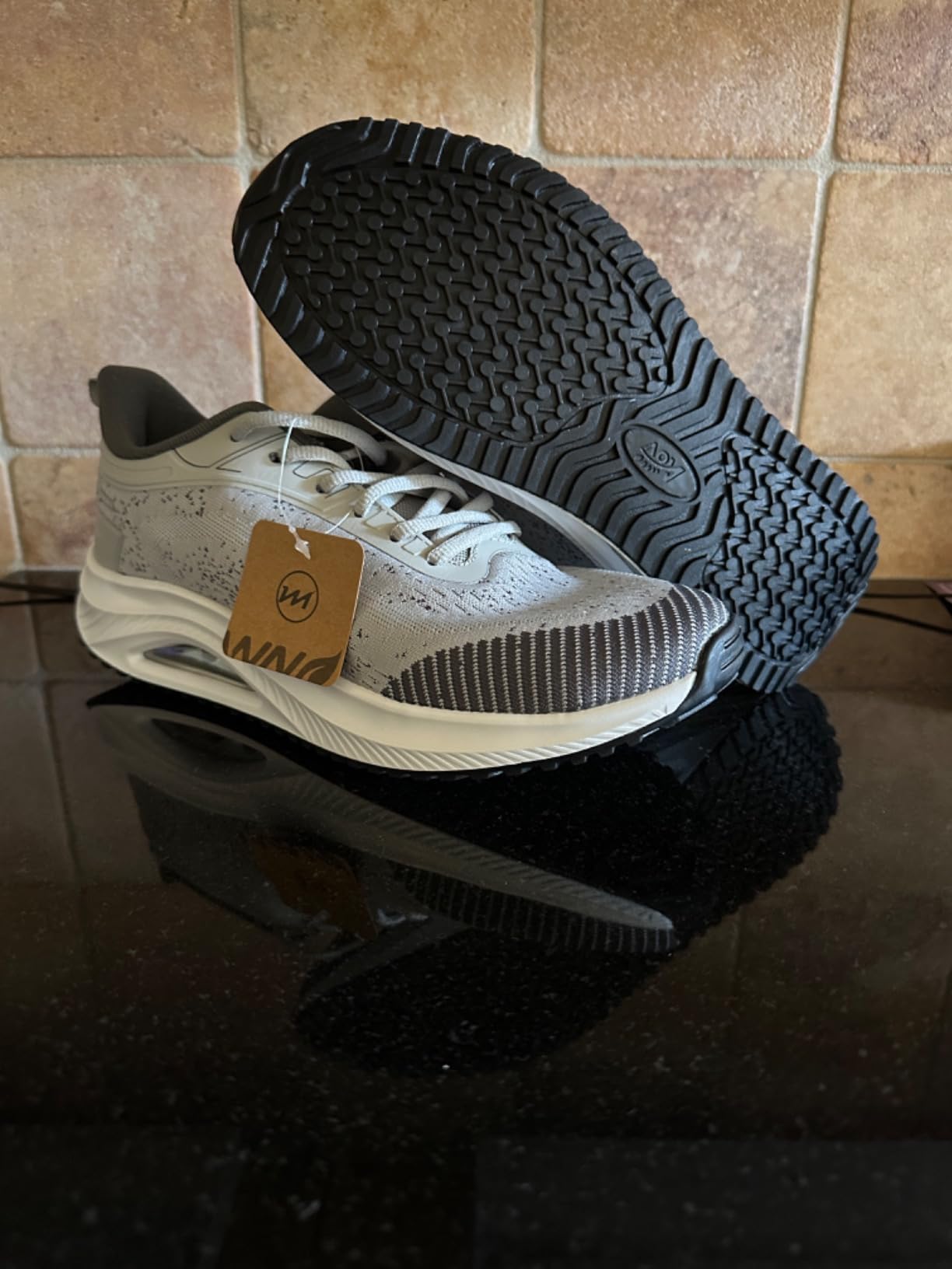 Close-up detail of RomenSi walking shoes showing breathable knit upper texture and pink accent details