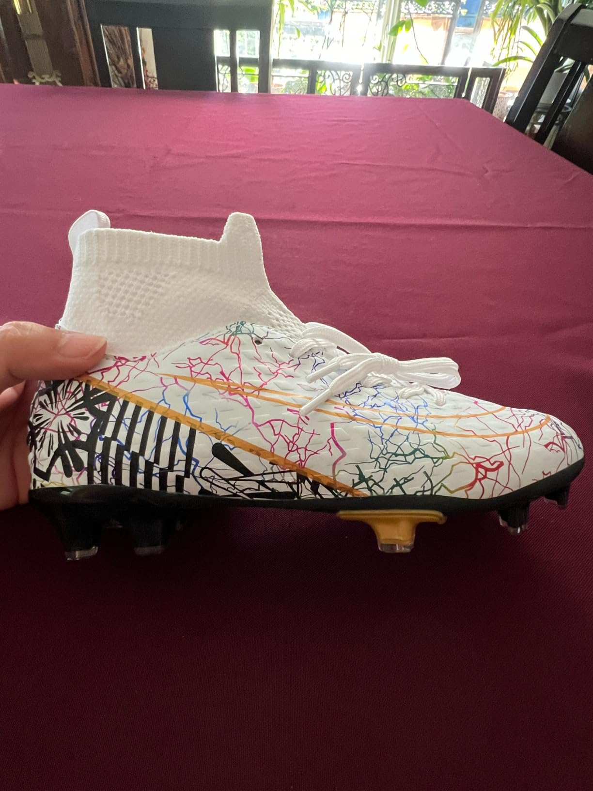 Youth high-ankle soccer cleats in white, gold and black colorway