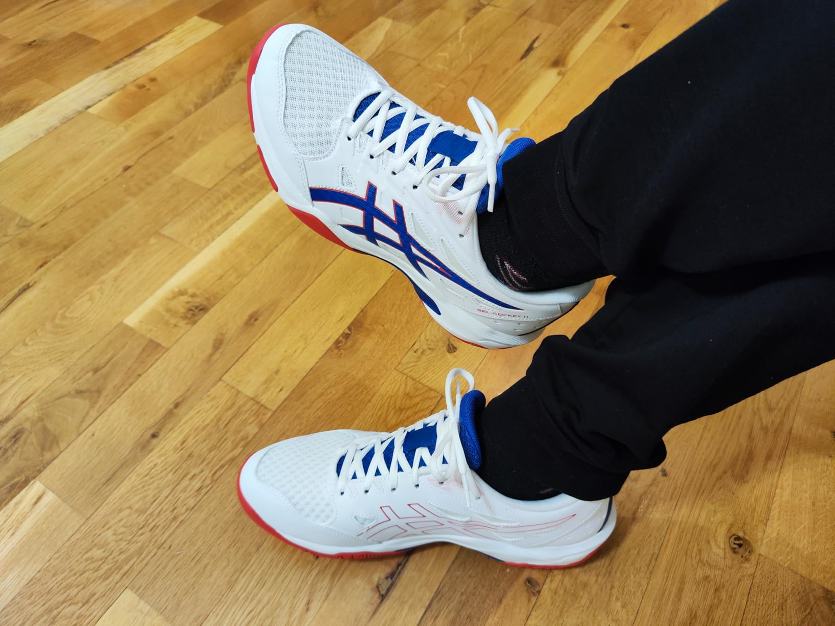 ASICS Gel-Rocket 11 upper construction detail showing breathable mesh and polyester overlay support zones