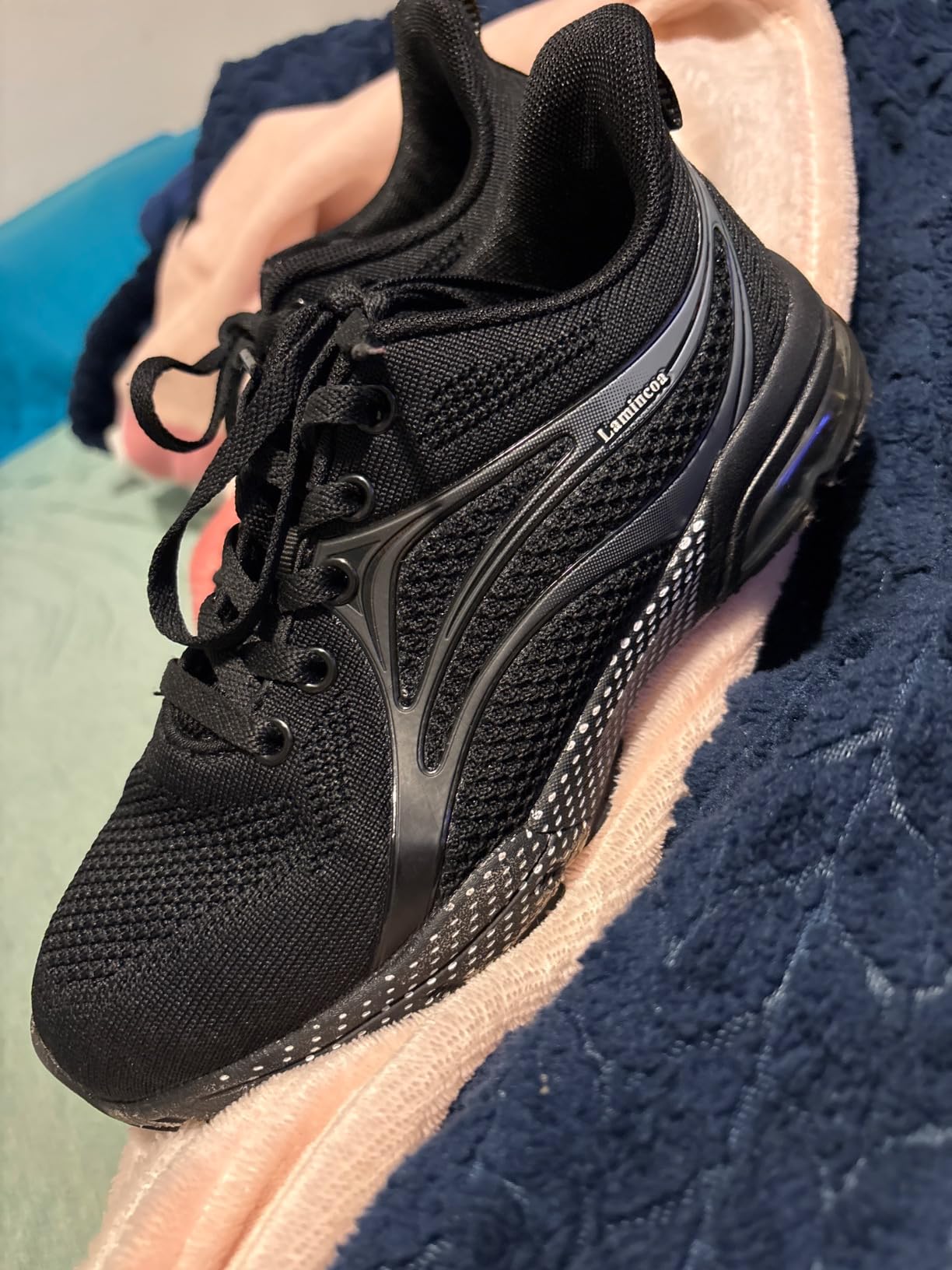 Detail view of ZOOMCO sneakers showing mesh construction and cushioned sole design