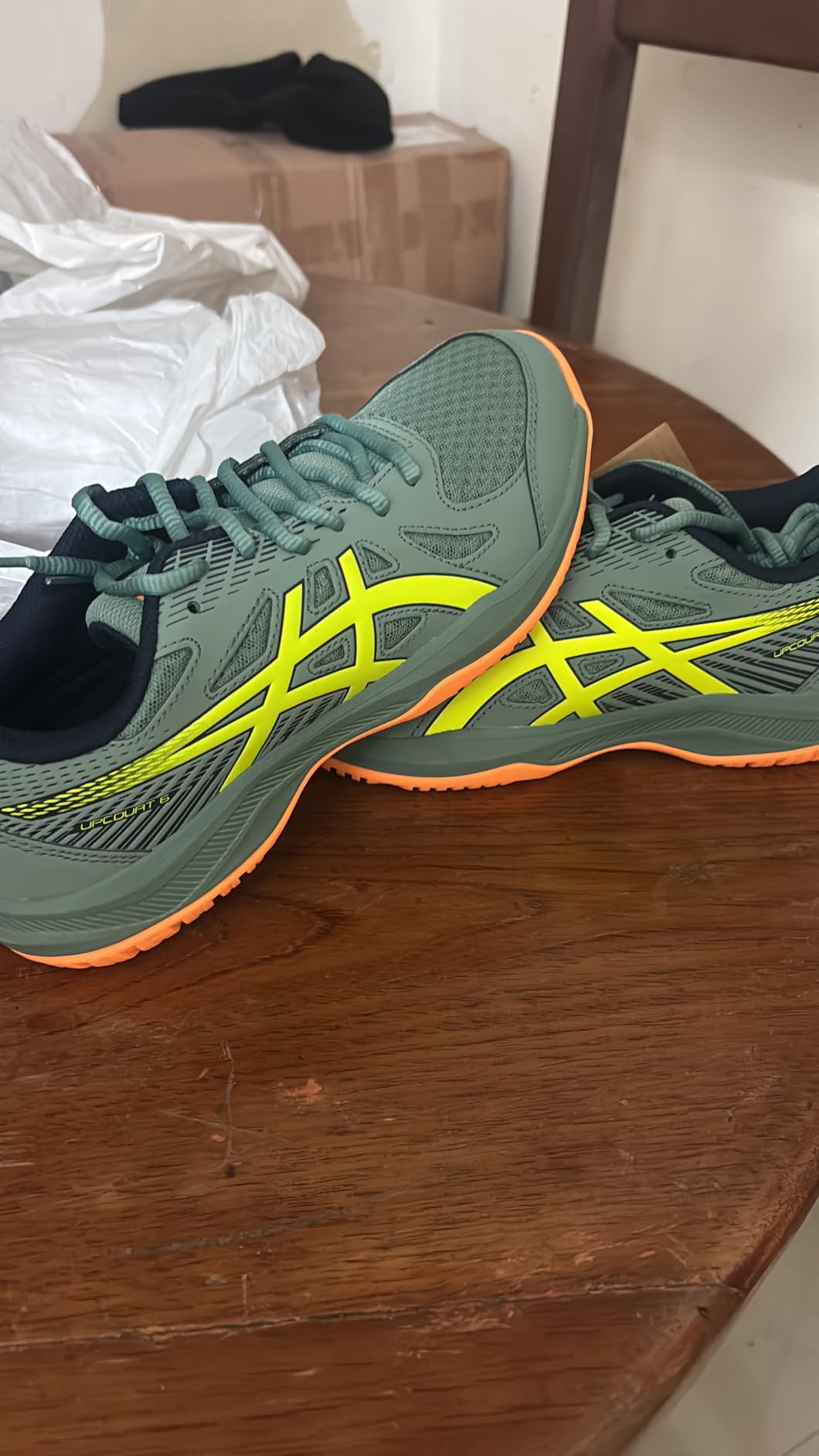 ASICS Upcourt 6 side profile showing polyester upper construction and supportive midfoot panels
