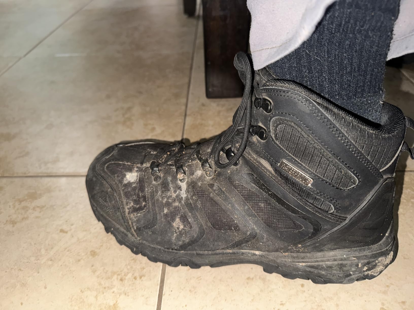 NORTIV 8 Armadillo boot construction detail showing reinforced stitching metal eyelets and rubber toe cap