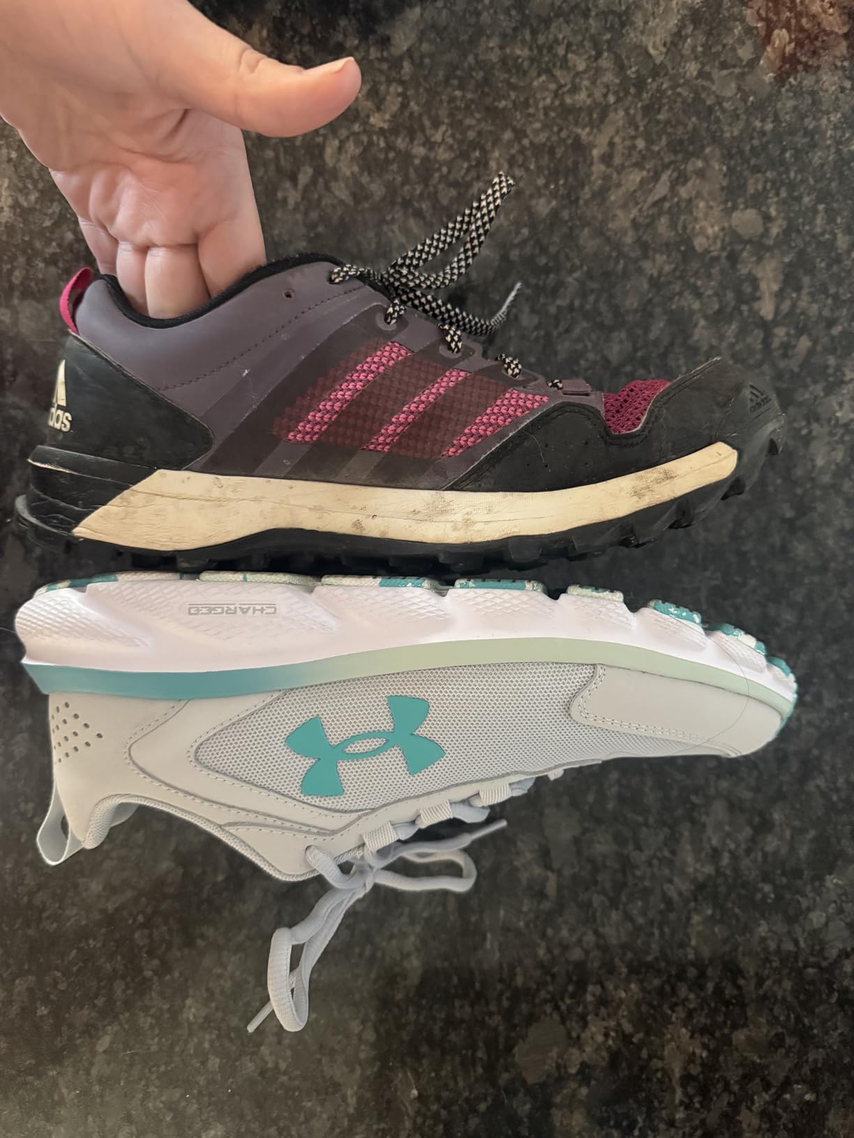 Side profile view of Under Armour Charged Assert 9 showing mesh upper and leather overlays detail