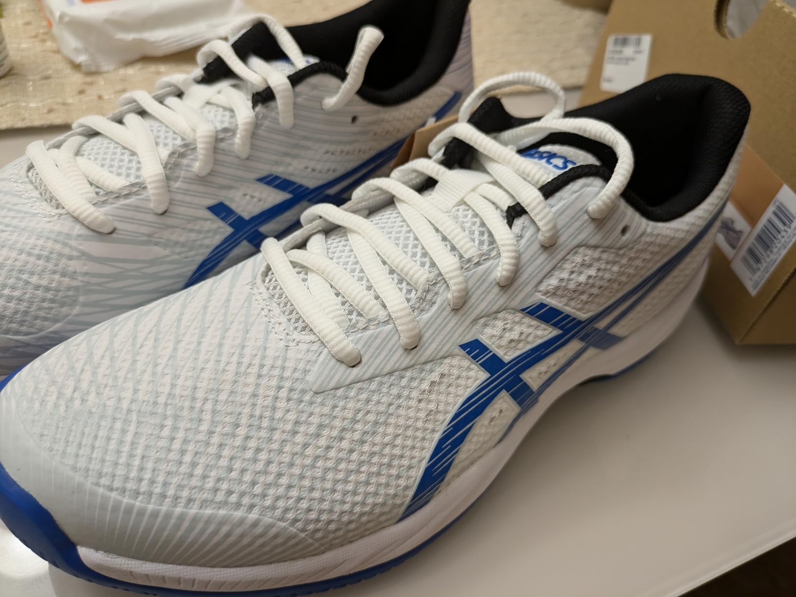 Close-up of ASICS Solution Swift FlyteFoam 2 outsole showing ASICSGRIP traction pattern with strategic rubber placement