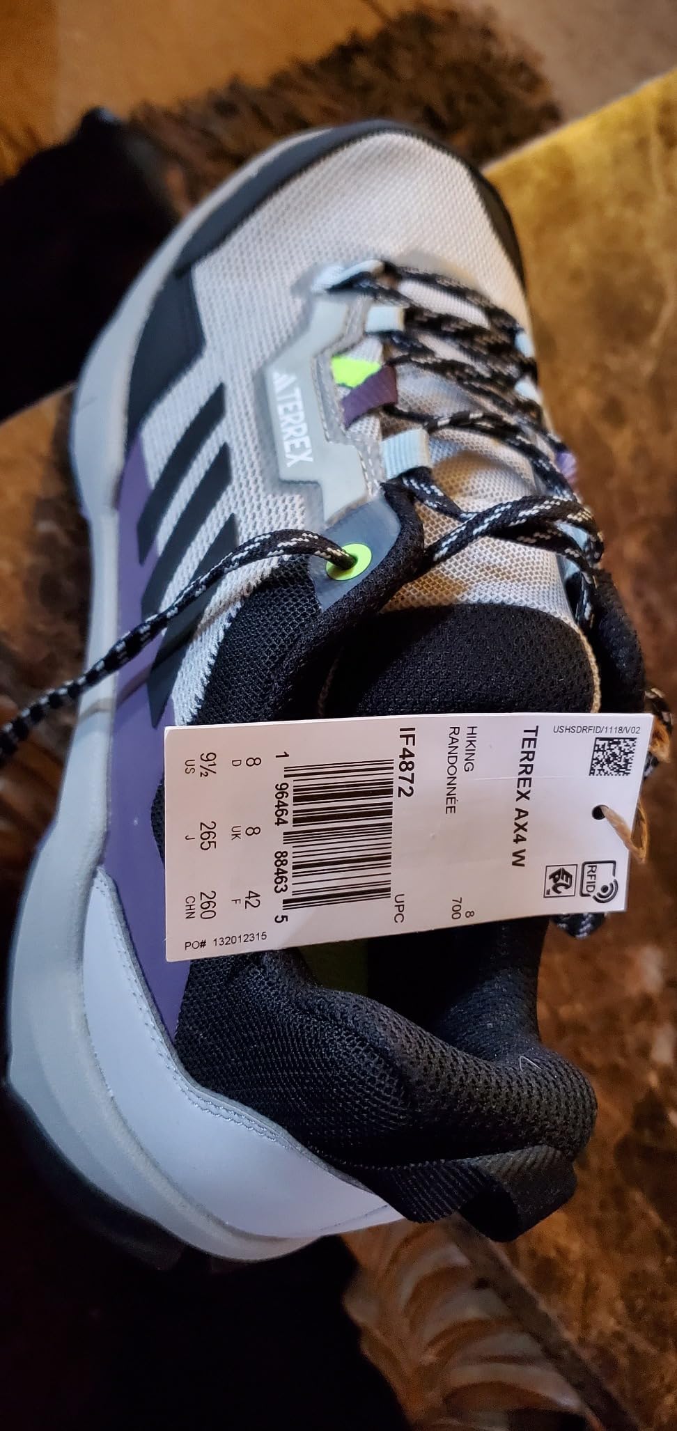 Side profile view of Adidas Terrex AX4 showing firm heel counter, midsole cushioning design, and low-cut construction