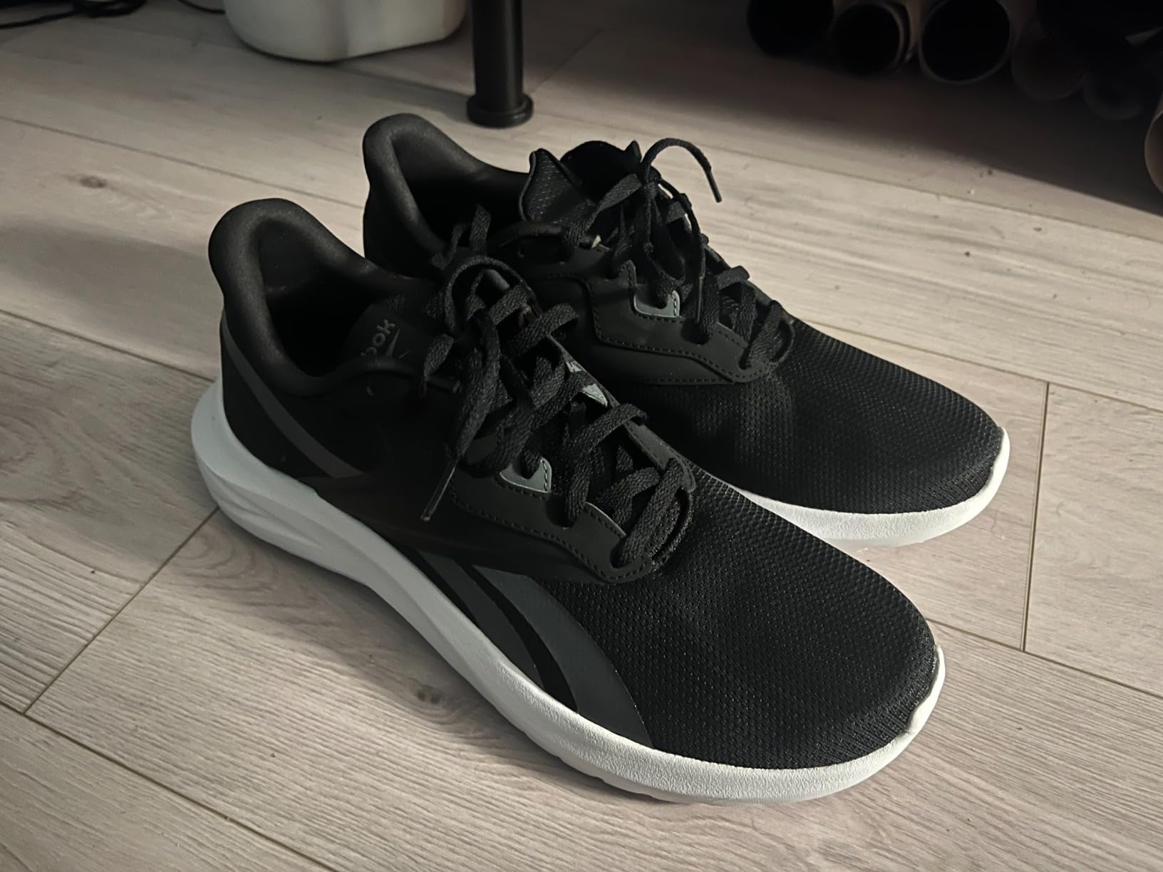 Reebok Men's Energen Lux Sneaker white grey colorway showing breathable mesh upper and EVA midsole