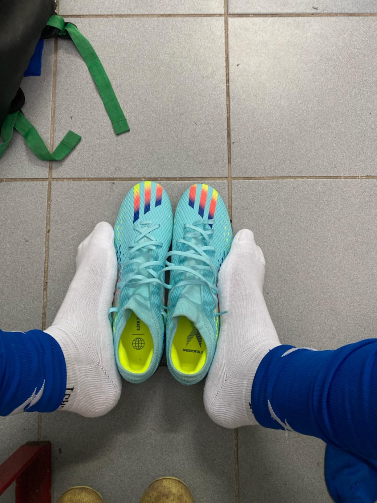 Adidas X Speedportal.3 youth soccer cleats showing firm ground stud pattern and speed-focused design