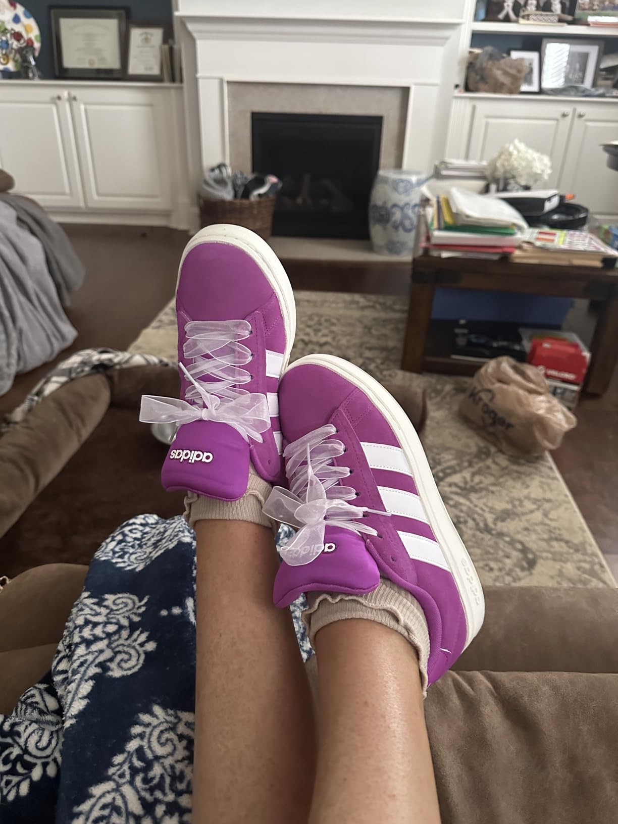 Close-up detail of Adidas Grand Court Alpha 00s showing synthetic leather upper and signature three stripes