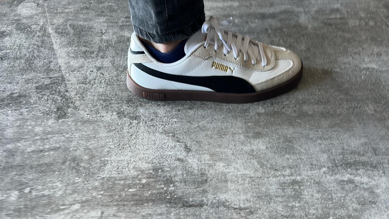 PUMA Club II Era on foot showing real-world styling with jeans demonstrating versatile casual aesthetic