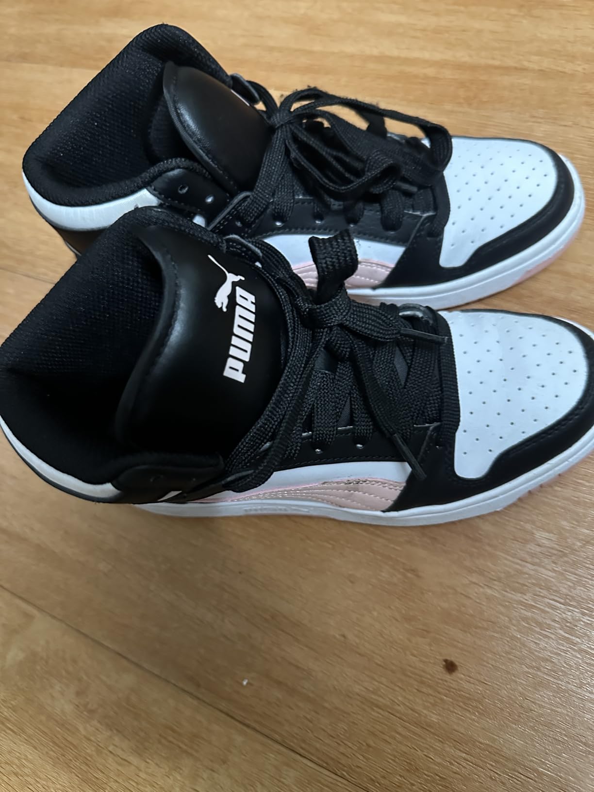 Close-up detail of PUMA Rebound Layup Mid showing synthetic leather upper material and padded collar construction