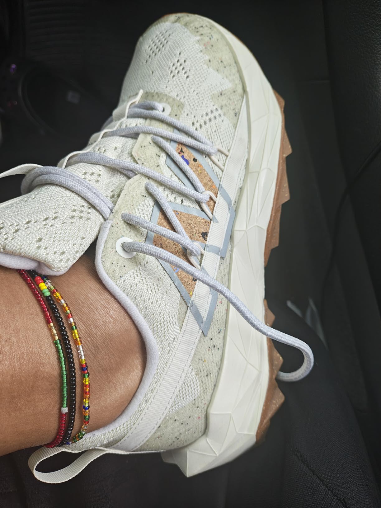 New Balance Women's Dynasoft Tektrel V1 in pink and sage green colorway, showing side profile with geometric design patterns