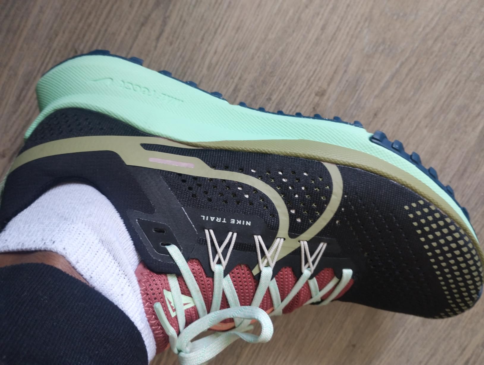 Close-up detail of Nike trail shoe engineered mesh construction and synthetic overlays