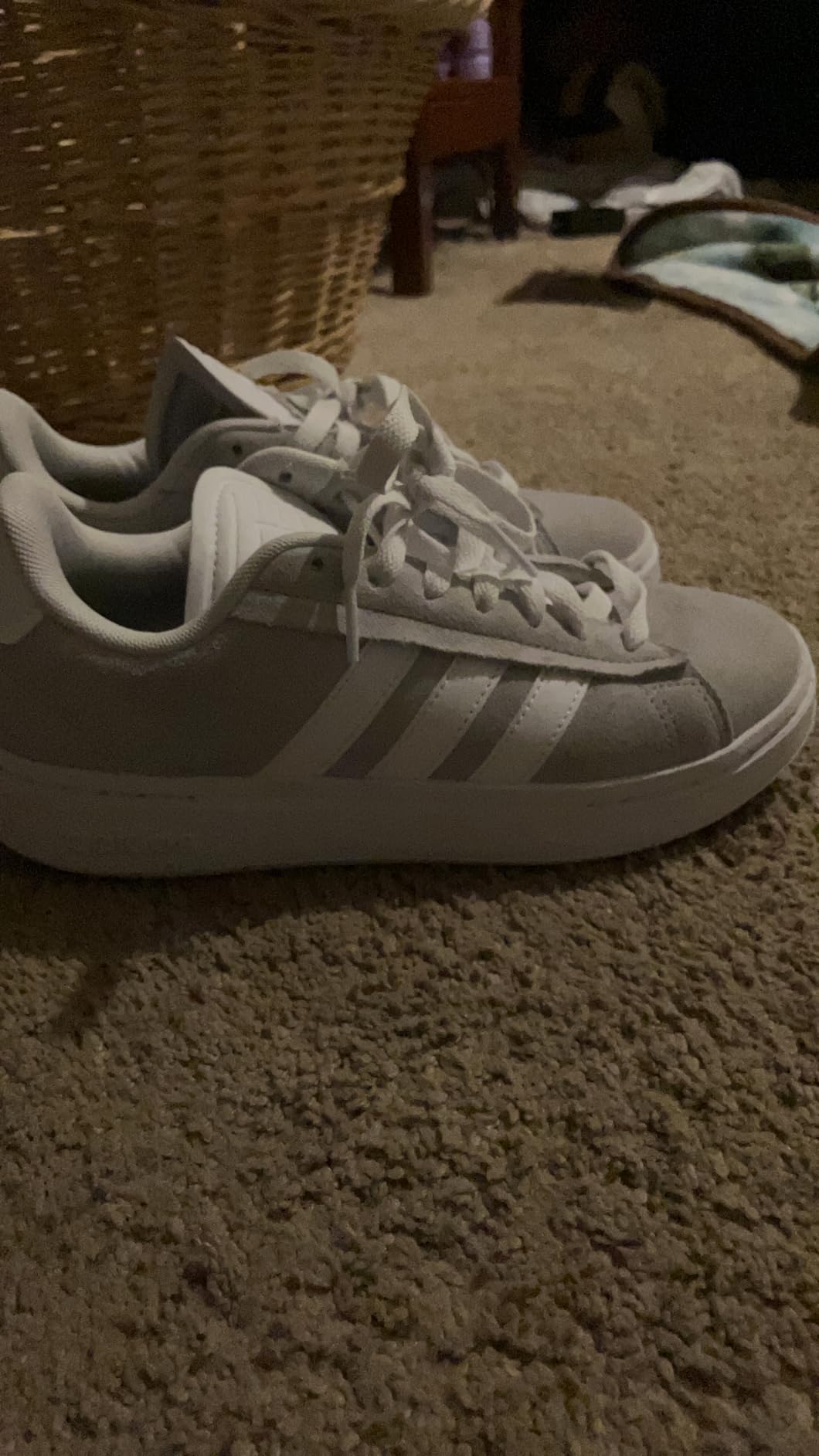 Adidas Grand Court Alpha detail view highlighting three stripes design and synthetic leather construction