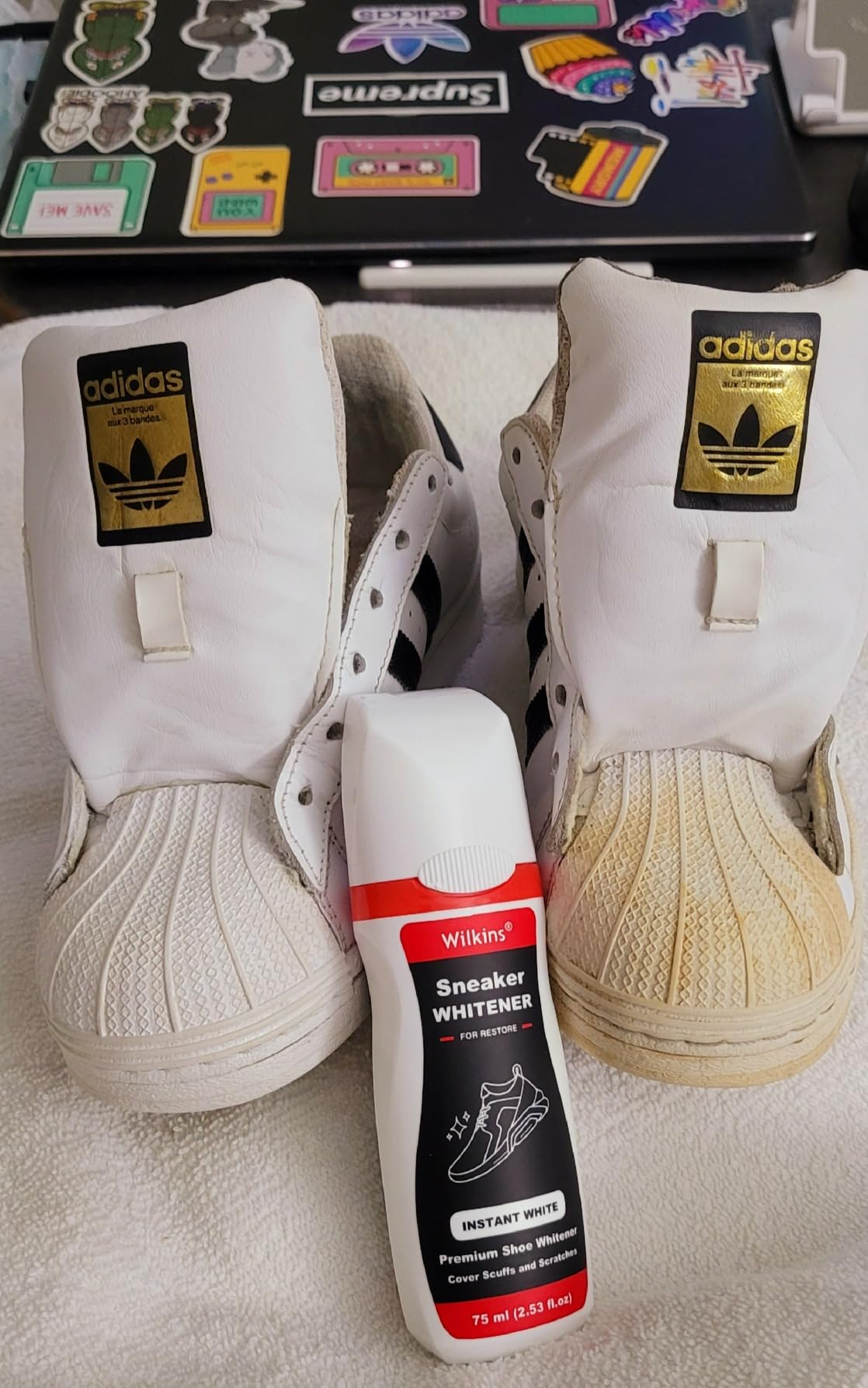 White leather tennis shoes showing Wilkins Sneaker Whitener application results in shoe creases