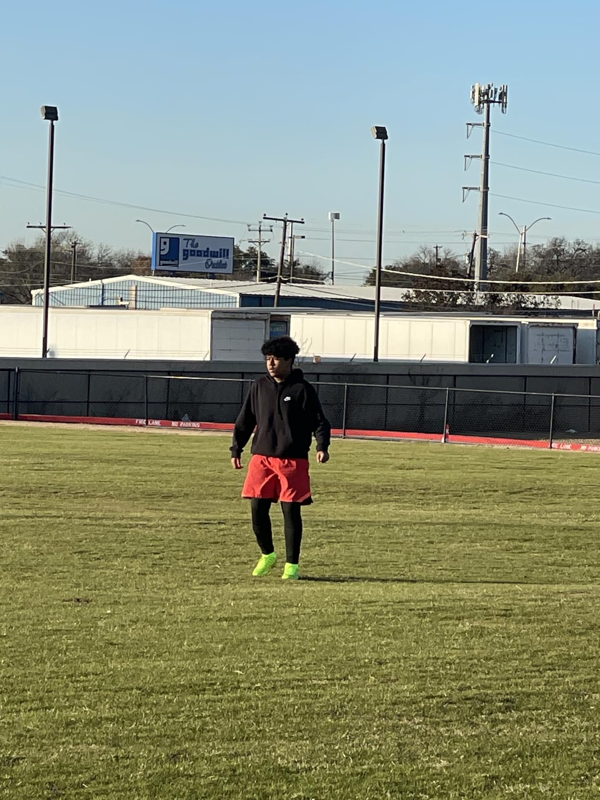 Men's high-top soccer cleats showing green colorway and ankle support design