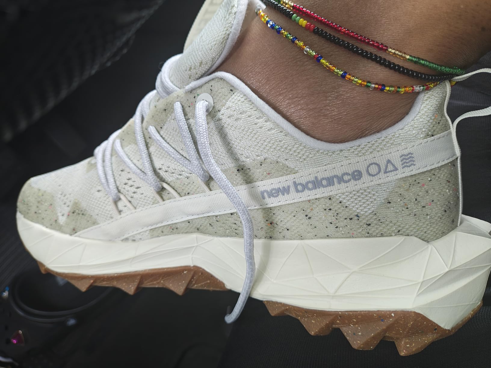 Close-up detail of New Balance Tektrel V1 upper construction showing mesh material, synthetic overlays, and unique angled lacing system