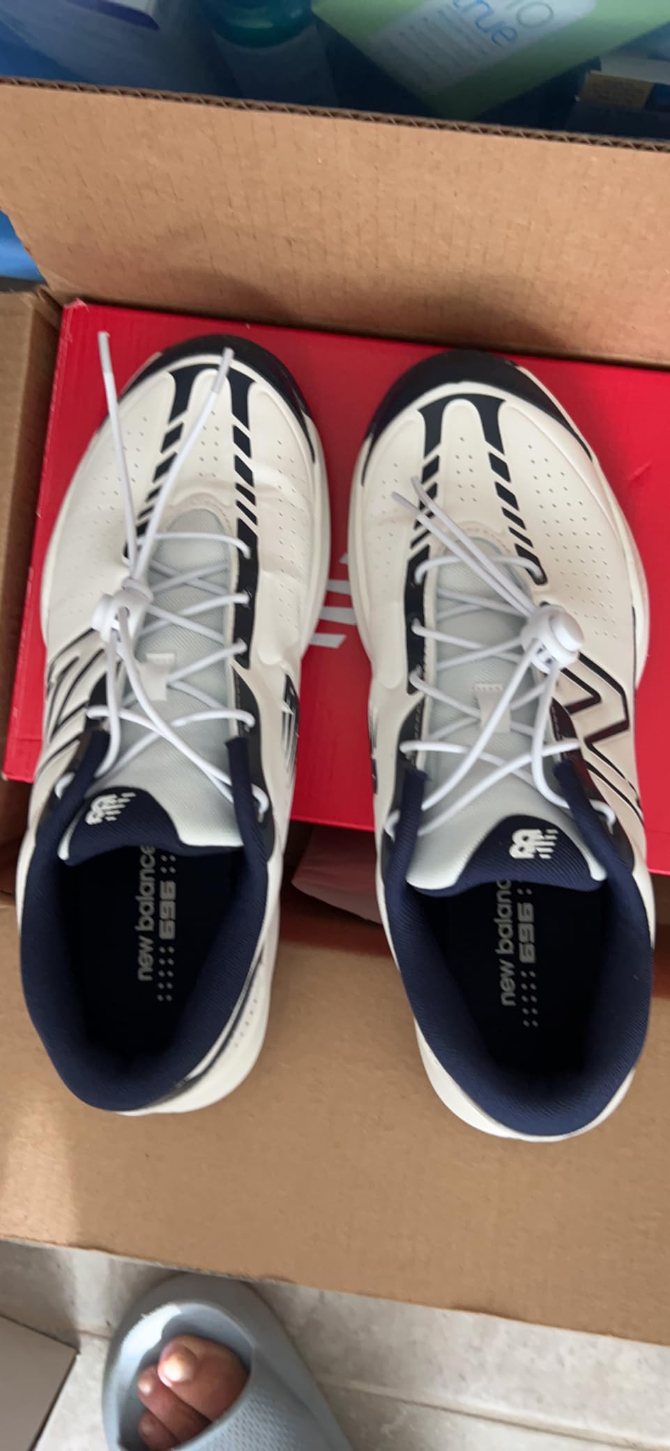 New Balance Men's 696 V5 side profile showing lateral support structure and court-specific design elements