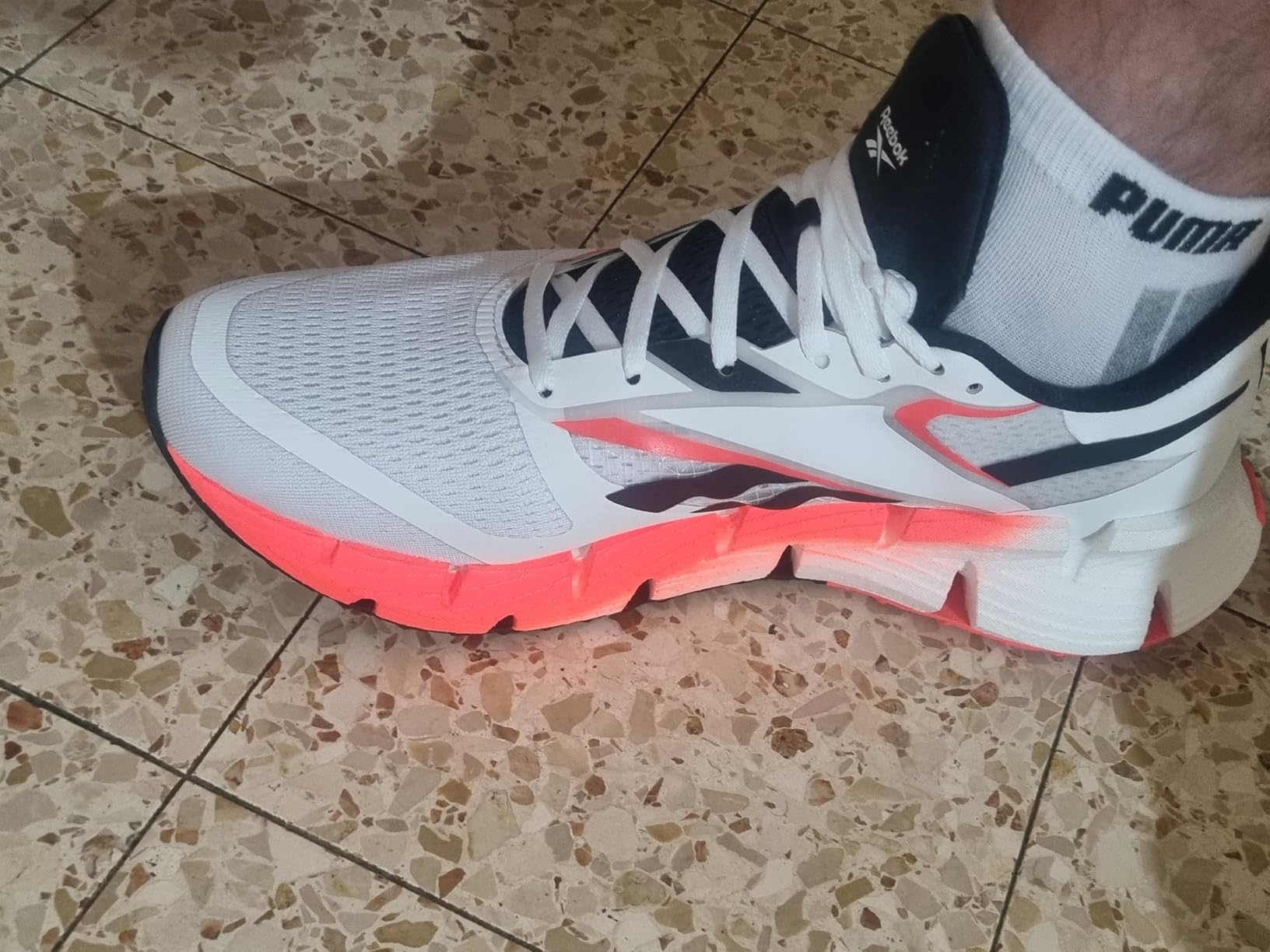 Reebok Floatzig 1 running shoe lateral view showing zigzag midsole pattern and engineered mesh upper